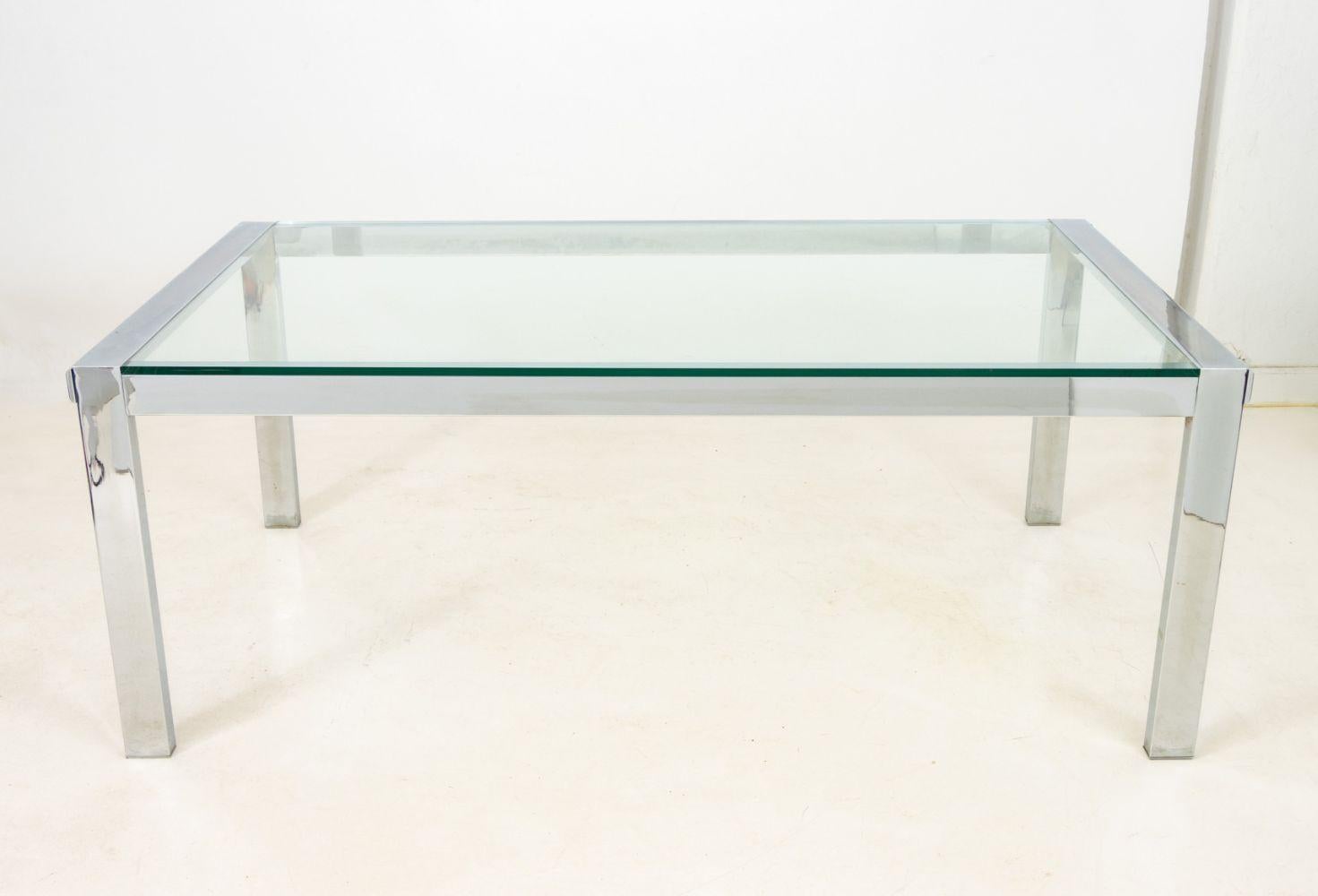 Modern Glass Top Chrome Plated Metal Dining Table, rectangular on four block legs.

29