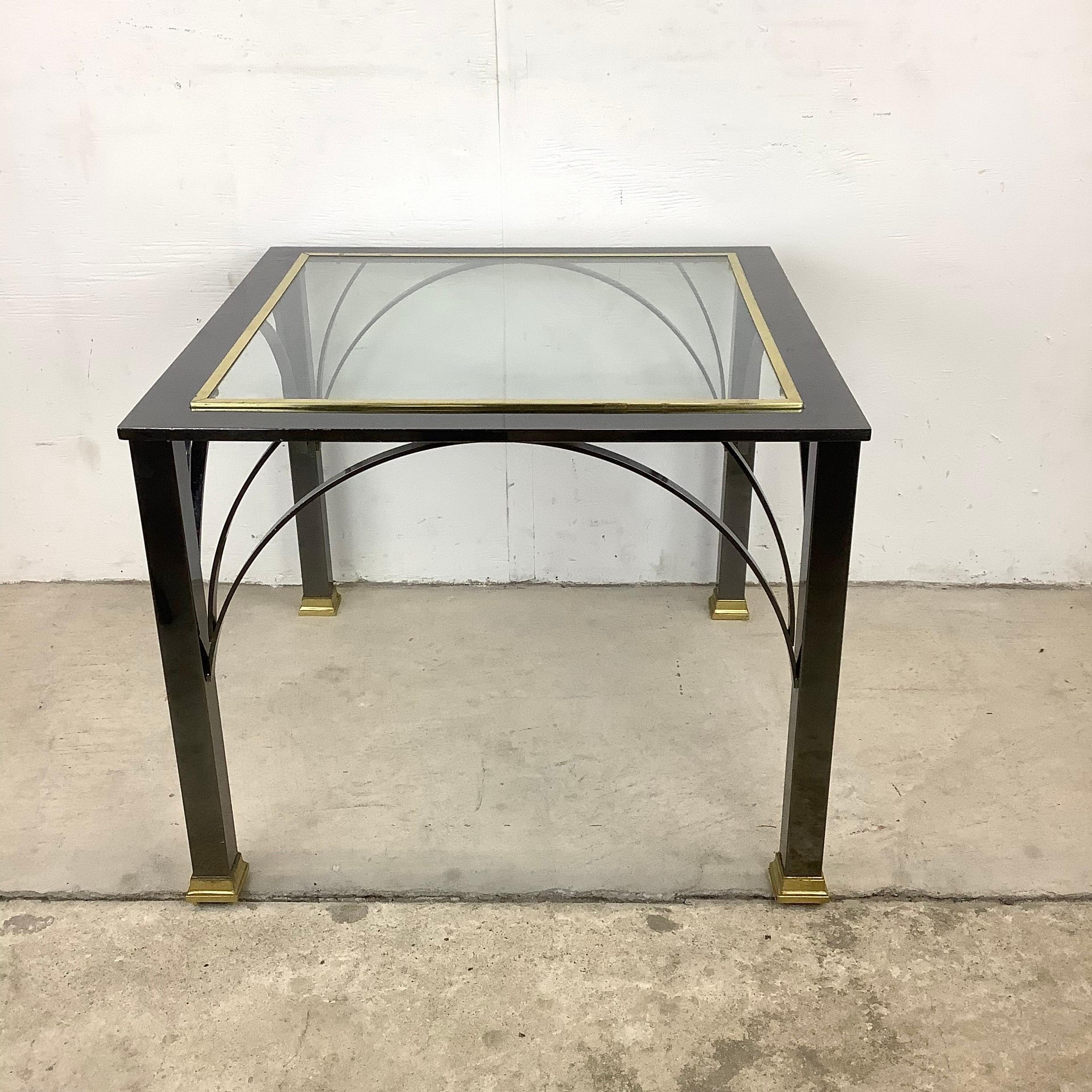 This stylish modern end table features an elegant mix of dark chrome and brass details, a sturdy table that makes an impressive addition in any seating area. Perfect height for use as a lamp table or sofa end table, with striking Milo Baughman style