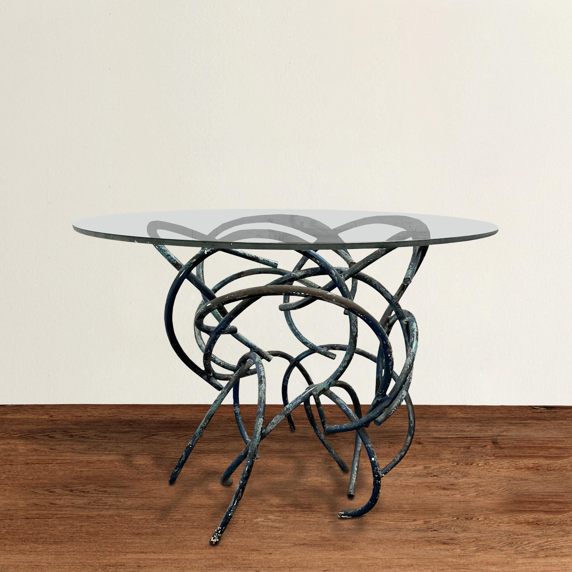 An incredible 20th century modern side table constructed from dozens of sculptural bent steel bars with a fantastic blue-gray painted finish, and with a glass top. Perfect next to your sofa, bed, or between two loungers by your pool!