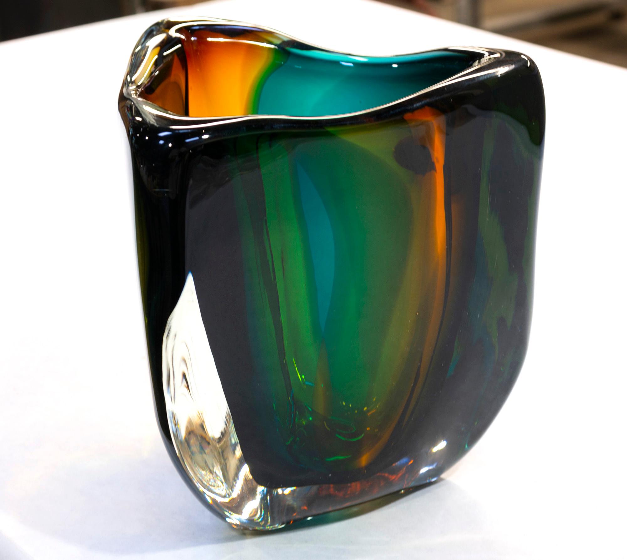 Modern glass vase, jungle low triangle by Siemon & Salazar
Measures: 8.5” T x 7.5” W
Made to order.

The glacier series is an exploration of glass and color in pure forms inspired by frozen ice flows and crisp clear light. Thick glass and