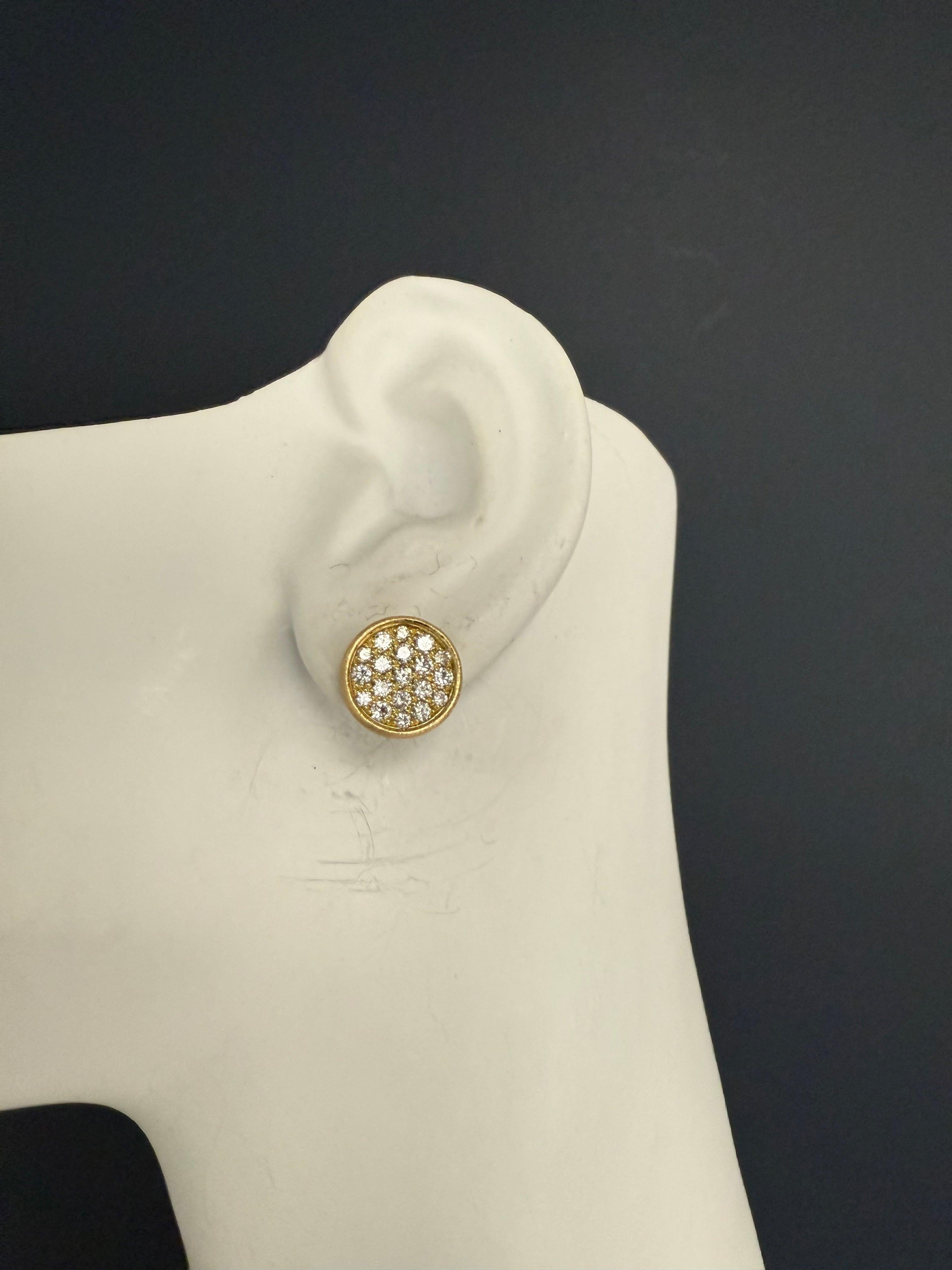 Elegant pair of 18K yellow gold earrings with a matte finish, designed in a round, dish-like form. Set with 38 natural colorless round brilliant diamonds totaling approximately 1.30 carats. The earrings measure approximately half an inch in diameter