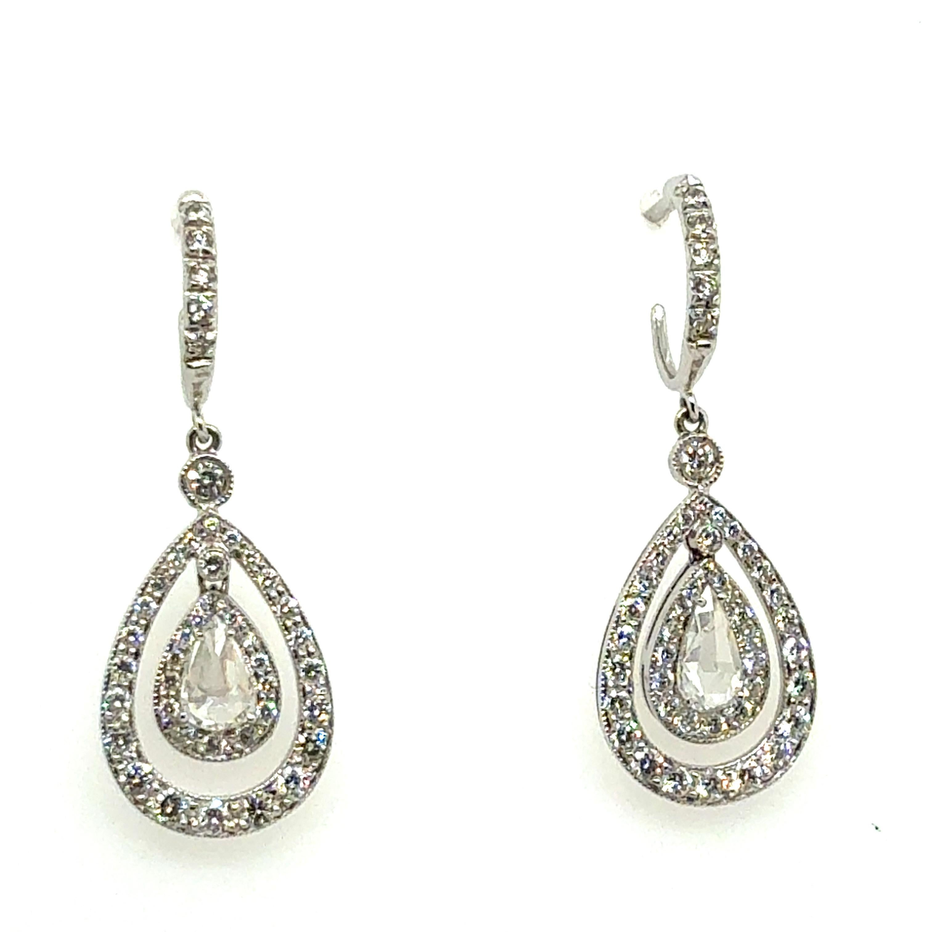 An elegant pair of drop earrings crafted in 14K white gold, stamped 585, with a refined balance of form and brilliance. The earrings measure approximately 1.25 inches in length and taper to a half inch width at the base, weighing a total of 4.5