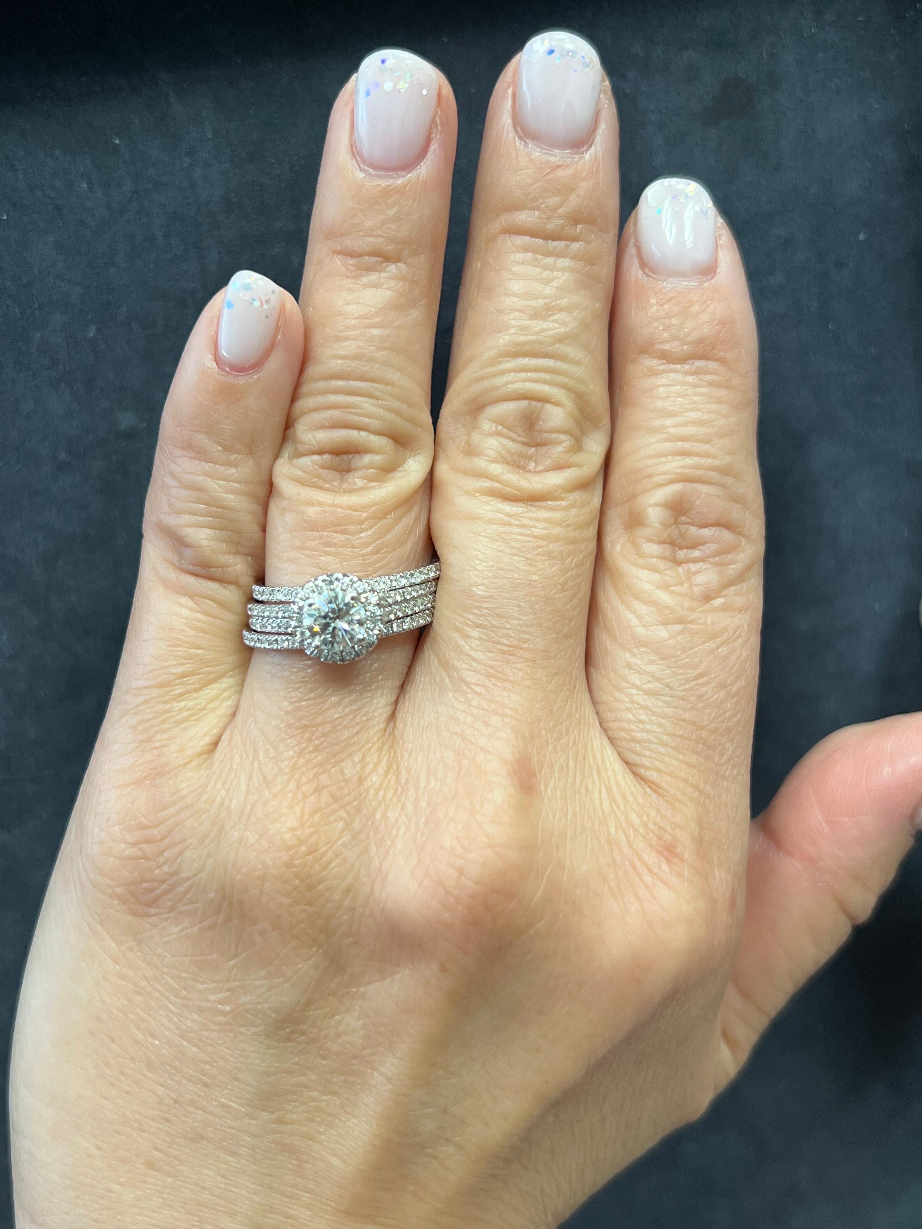 One Lady's 14k White Gold and Natural Diamond Ring Set.

The center stone is a natural round brilliant weighing 0.75 carats measuring 6.00-5.96x3.8mm. Approximately H in color and SI1 in clarity. The inclusions are pleasant and Eye-Clean.