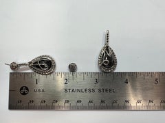 Modern Gold 23 Carat Natural Colorless and Black Pear Shaped Diamond Earrings