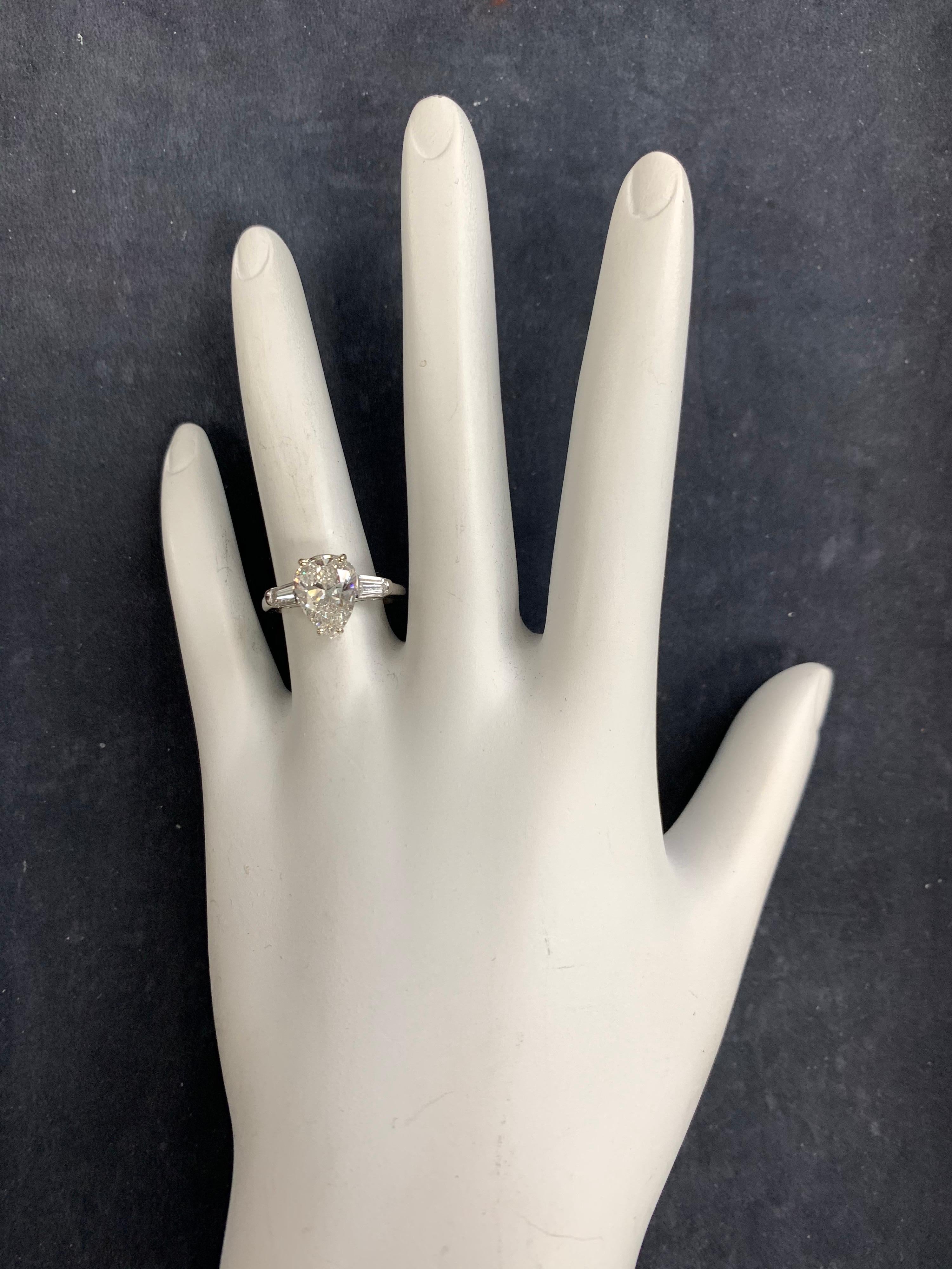 A Stunning 18k White Gold Pear Brilliant Engagement Ring set with a 2.09 carat EGL Certified Natural Pear Diamond G in color and SI1 in clarity. 

Flanking the cnterstone are two colorless tapered baguette natural diamonds measuring approximately