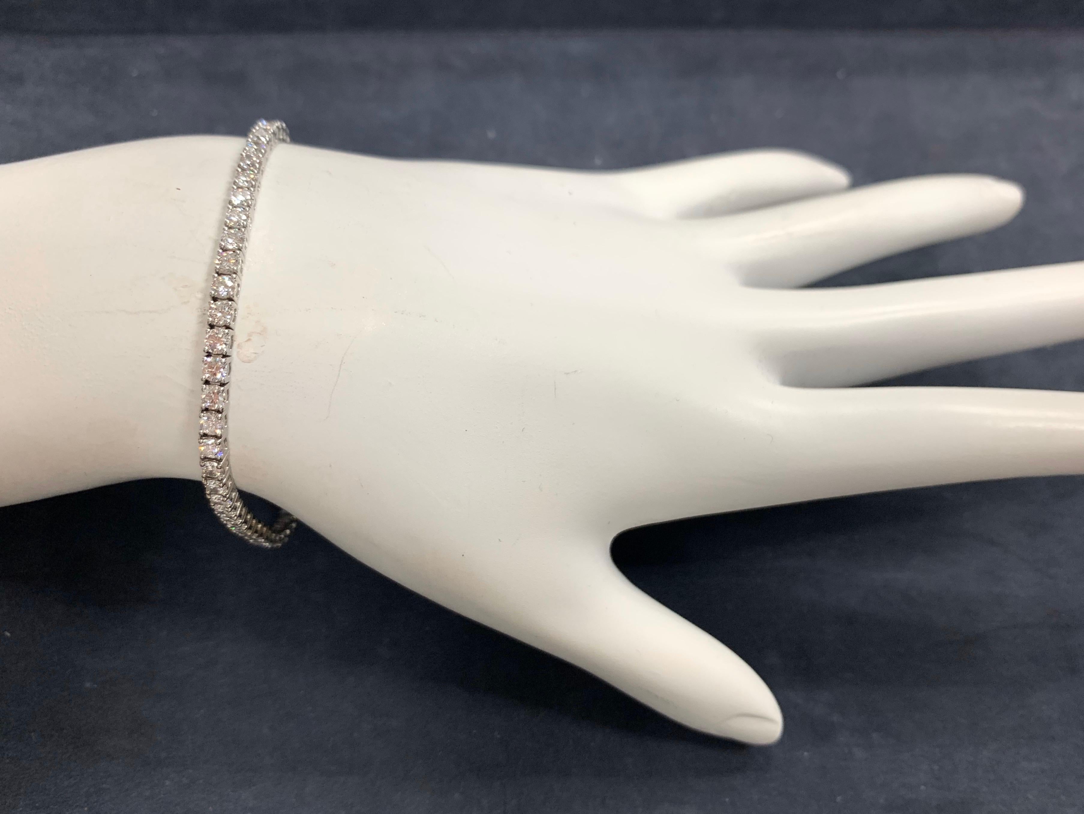 Stunning 14K White Gold Classic Tennis Bracelet weighing 3.50 carats. 

It is set with 69 ideal cut natural round brilliant diamonds measuring 2.35mm, approximately F-G in color and VS2-SI1 in clarity. 

The bracelet itself weighs 6.5 grams and is 7