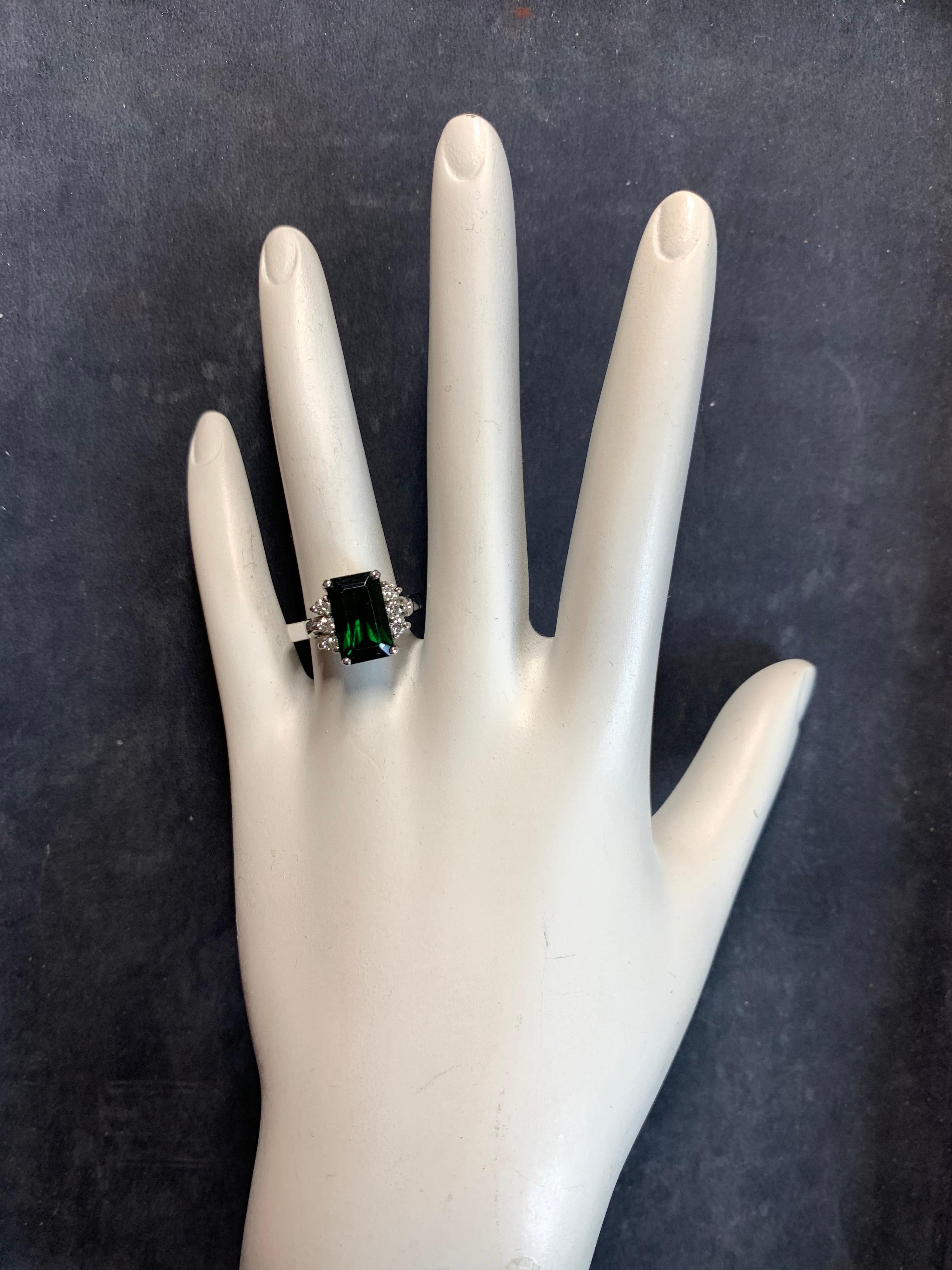 Modern Estate 14k White Gold 4 Carat Natural Green Tourmaline Gemstone & Diamond Cocktail Ring. 

The Deep Green centerstone measures 11.3x6.9x5.7mm and weighs approximately 3.75 Carats. 

It is flanked by six natural colorless 2mm round brilliant