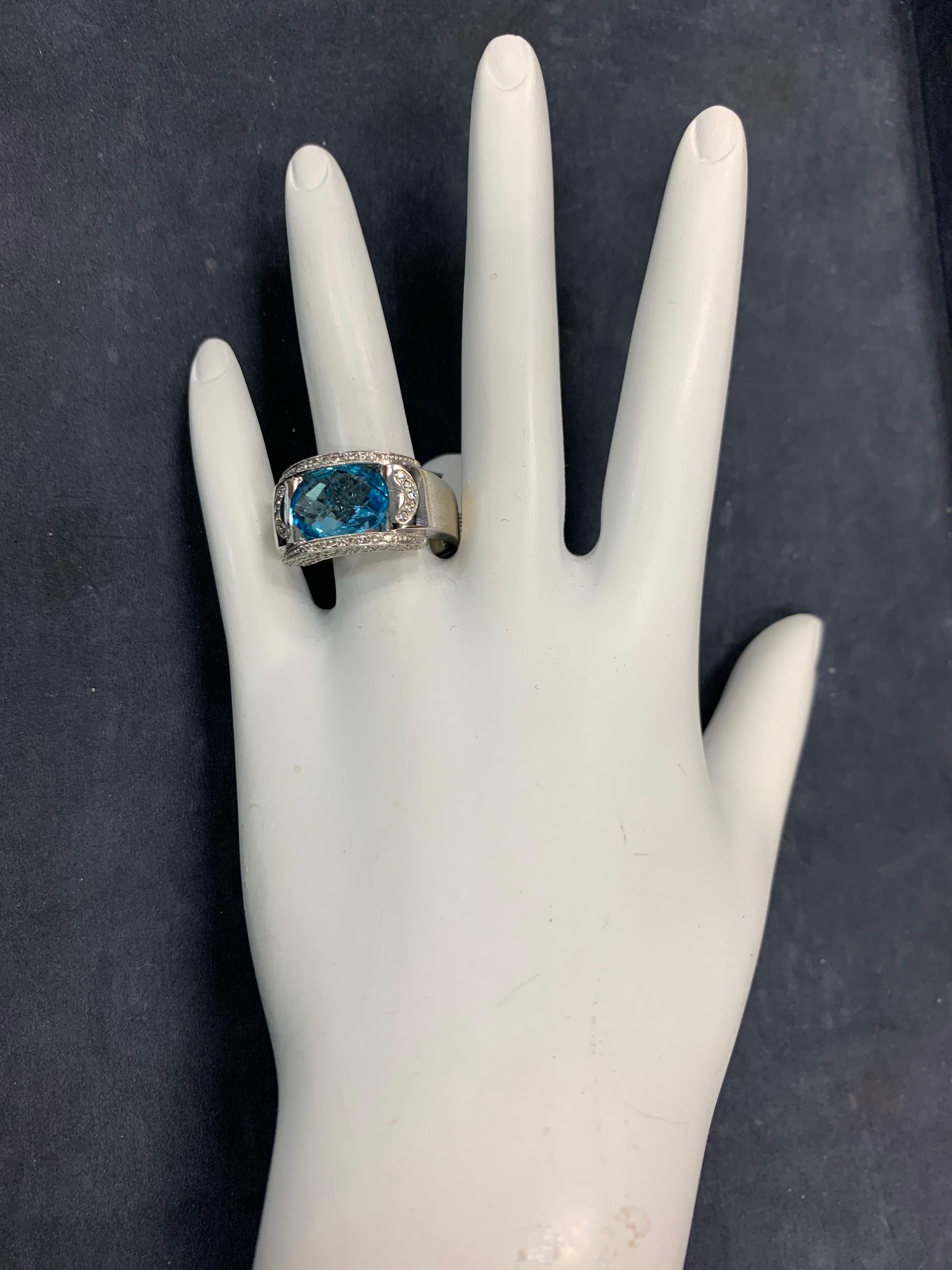 Modern 14k White Gold 5.43 Carat Natural Oval Blue Topaz & Colorless Diamond Cocktail Ring. 

The centerstone is a 4.90 carat oval cut topaz and the natural colorless diamonds weigh 0.53 carats.

The ring weighs 11.2 grams and is a size 7.5.
