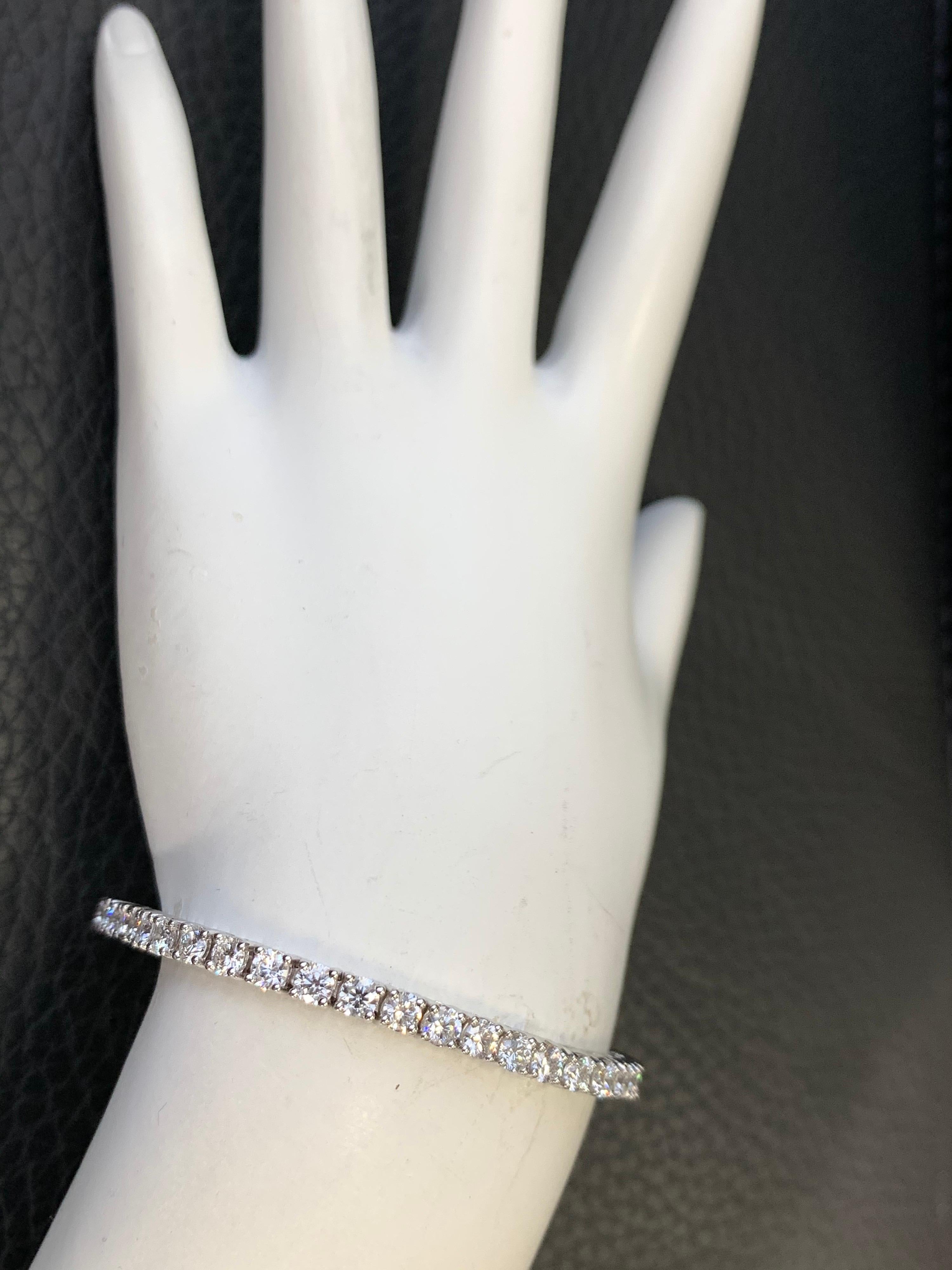 Stunning 14K Gold Classic Tennis Bracelet weighing 6.75 carats. 

It is set with 49 ideal cut natural round brilliant diamonds measuring 3.3mm, approximately F-G in color and VS2-SI1 in clarity. 

The bracelet itself weighs 13.9 grams and is 7