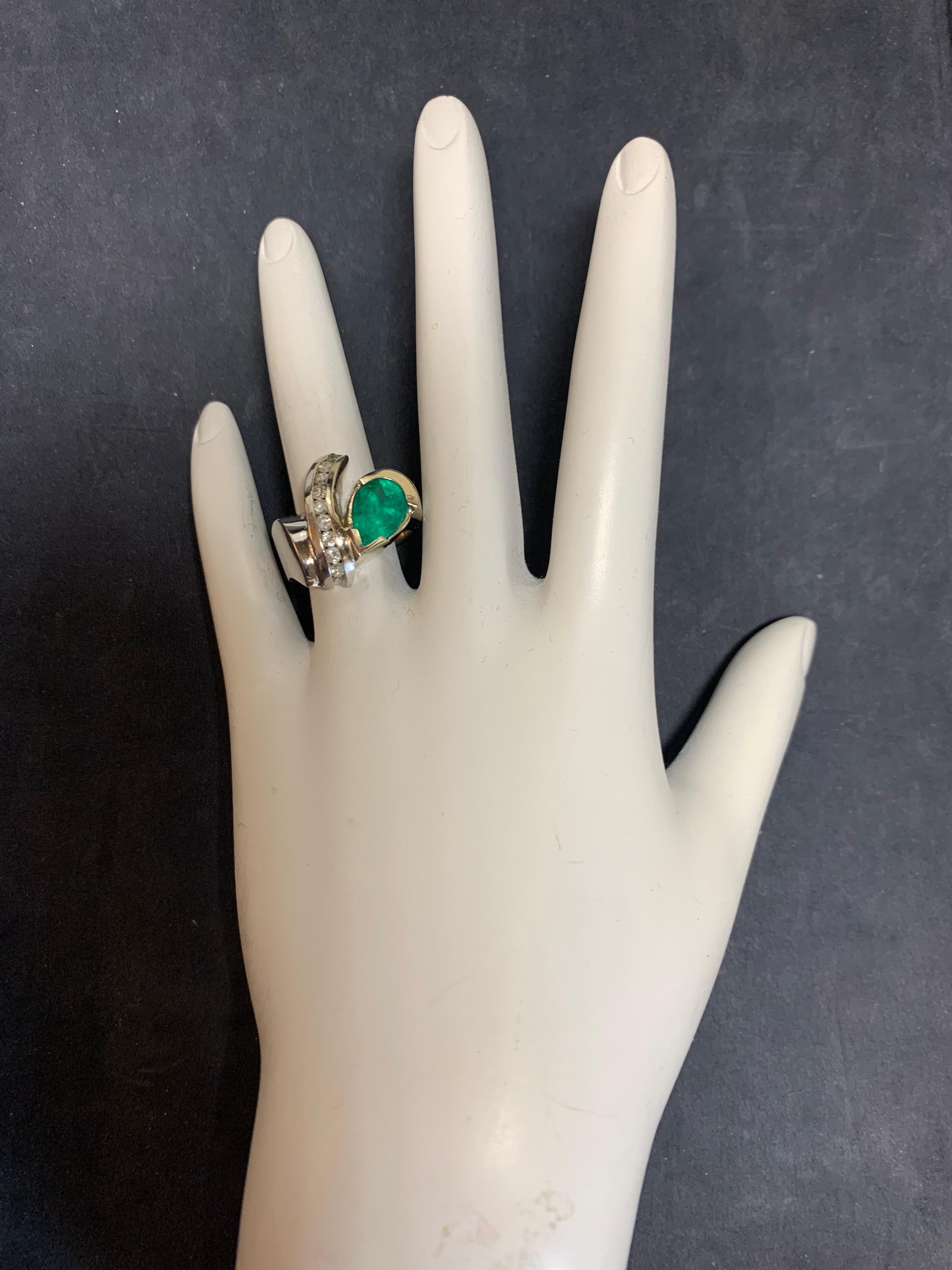 Modern 14k White Gold Cocktail Ring. Set with an approximately 2.75 carat Pear Shaped Emerald (11x7x5.8mm) and 9 natural round brilliant diamonds weighing approximately 0.50 carats, H in color, SI in clarity. 

The ring size is a 7, ring weight is