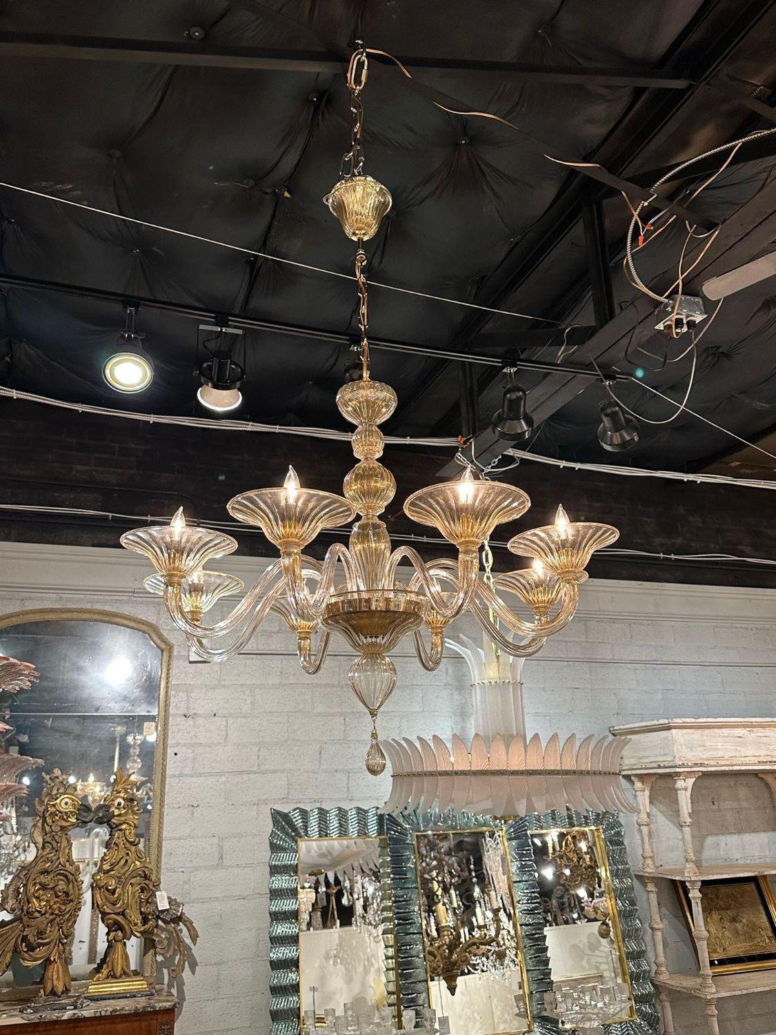Lovely modern gold glass Murano chandelier with 8 arms. Makes a beautiful statement!