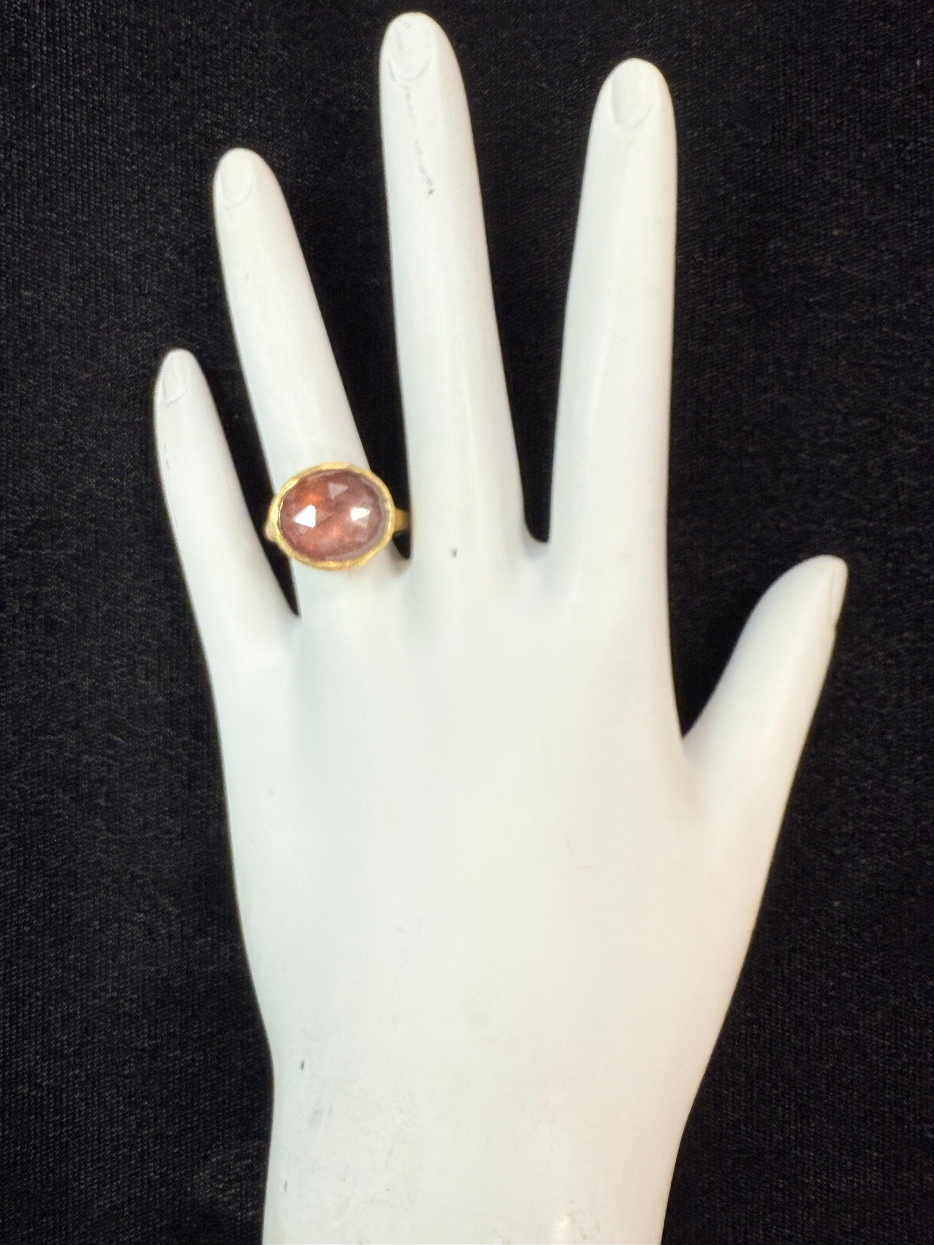 Modern brushed yellow gold statement ring by renowned Italian designer Marco Bicego, from the Jaipur collection. It features one stunning rose-cut pink tourmaline set horizontally, measuring approximately 13.5 x 11.5 mm. The ring’s total width is