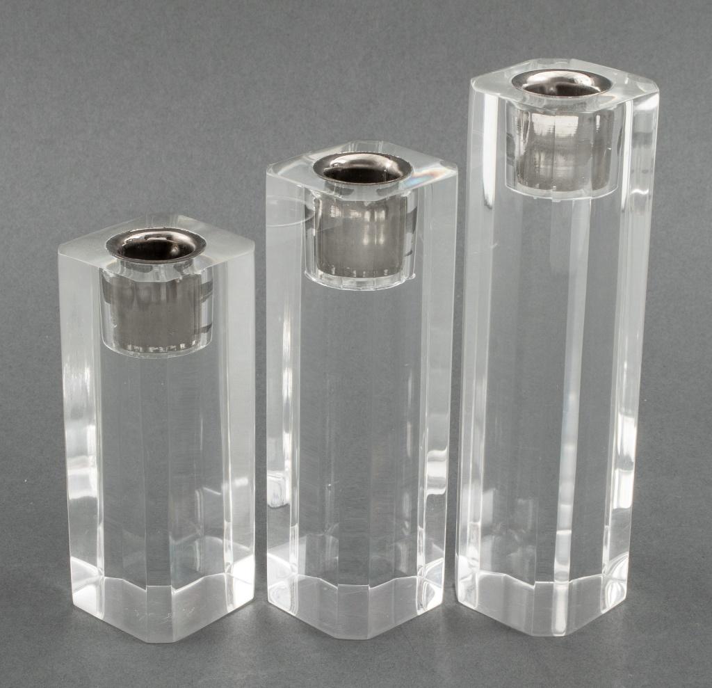 Three Modern lucite candlestick holders of graduated heights, in the style of Charles Hollis Jones (American, b. 1945). Tallest: 7