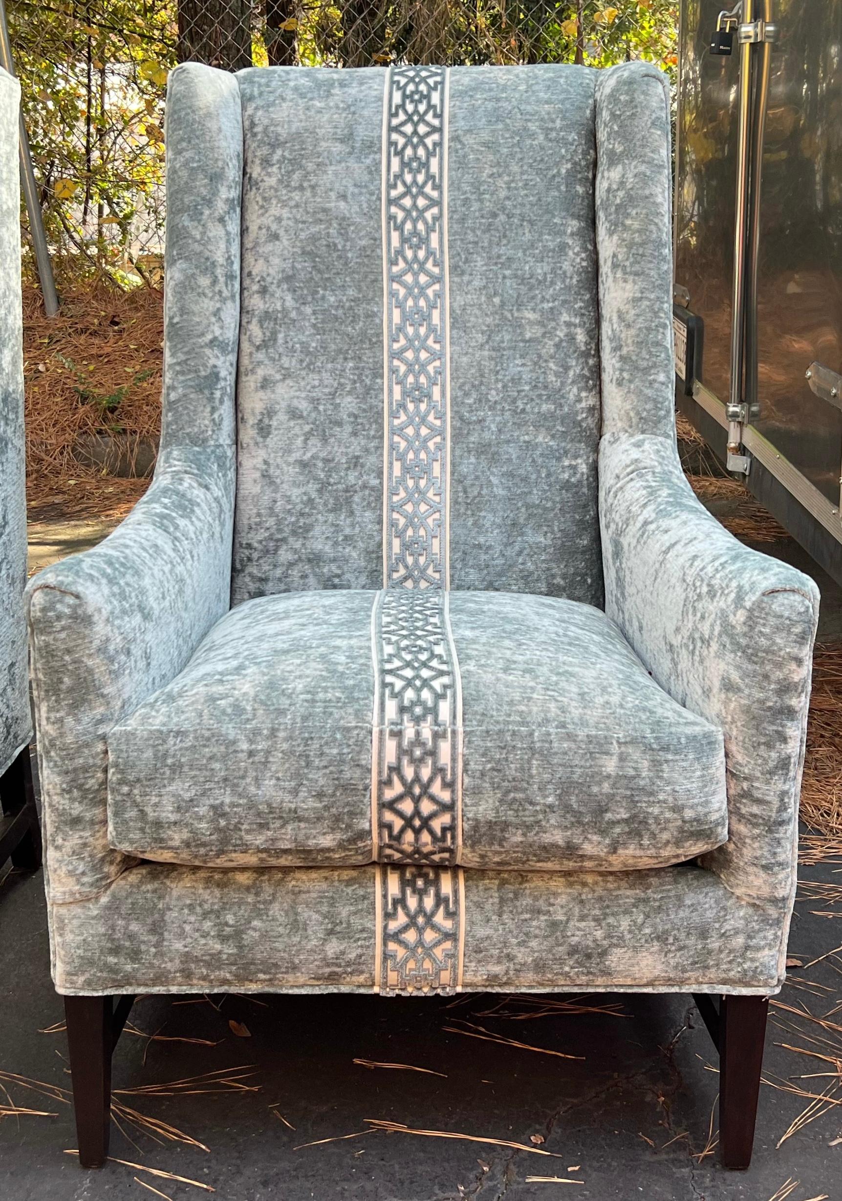 These striking chairs were hand crafted by Massoud. They have somewhat of a large scale. The fabric is a gray crushed velvet, and the feet are an ebonized wood. They are marked and in very good condition. Arm; 25”. Seat; 20.5”.