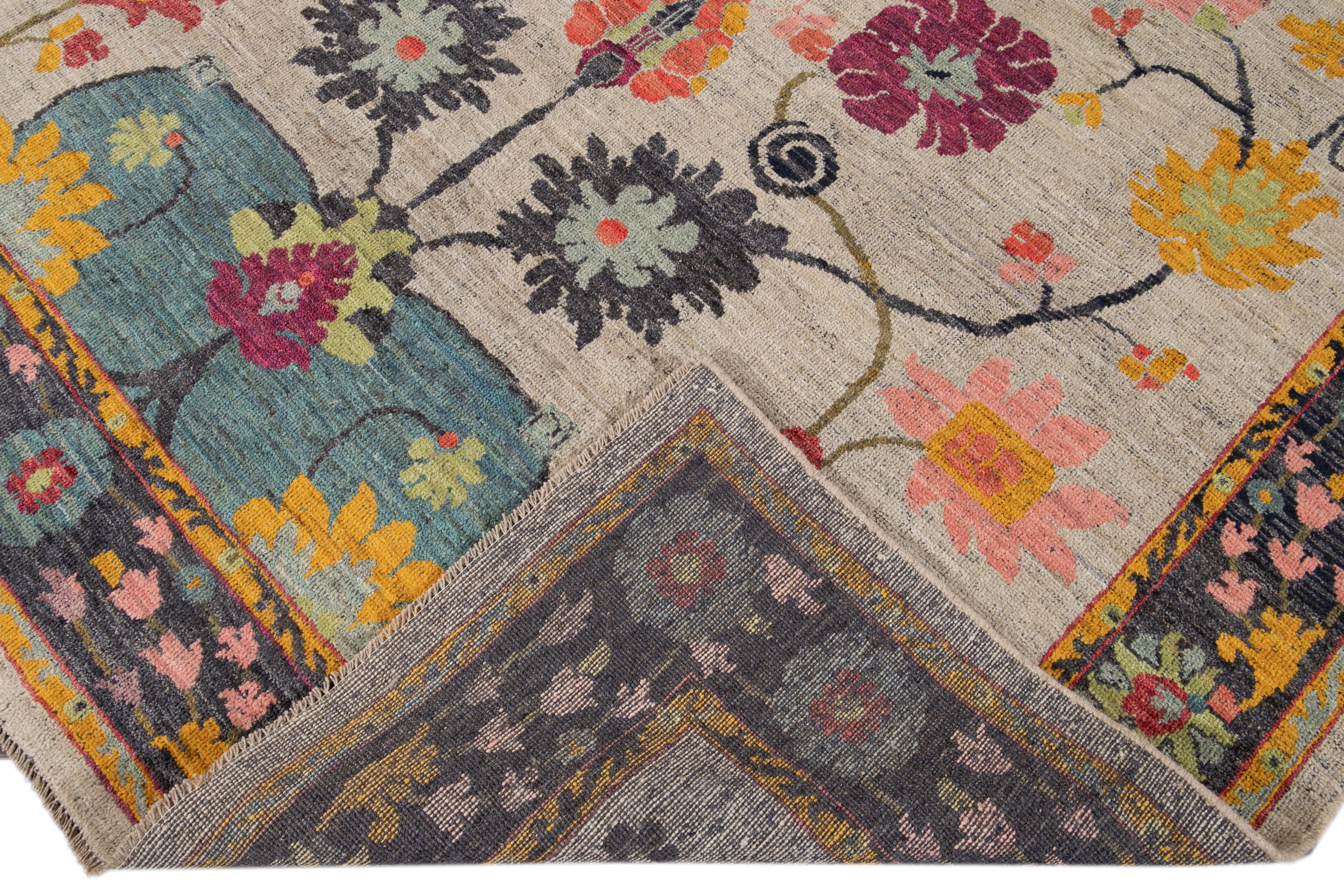 Beautiful modern Oushak hand knotted wool rug with a gray field. This Oushak rug has a blue frame and multi-color accents all-over a gorgeous botanical floral design.

This rug measures 8'1