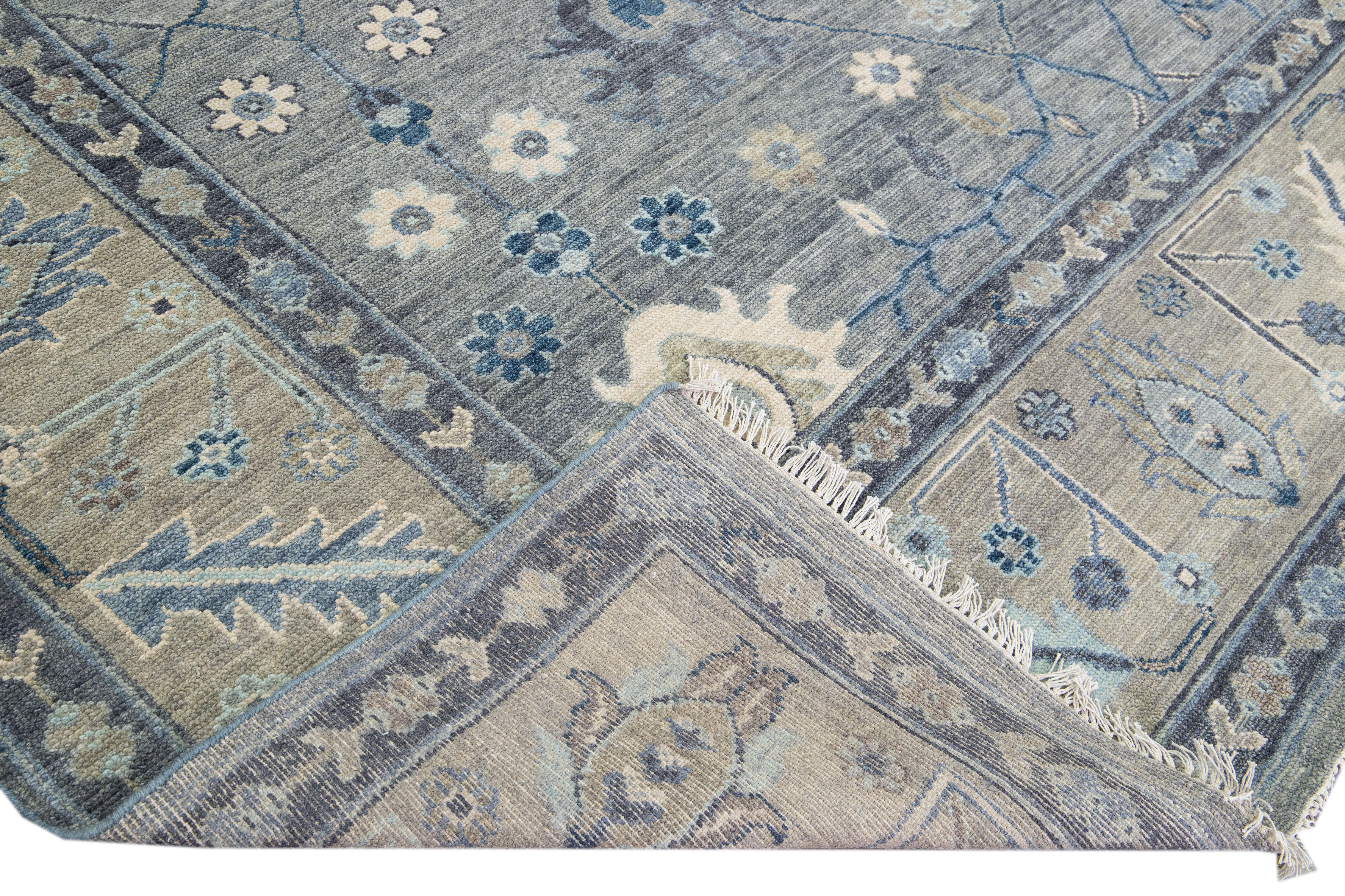 Beautiful modern Square Oushak hand-knotted wool rug with a gray field. This Oushak rug has a beige designed frame and blue accents all over a gorgeous floral design.

This rug measures 11' x 11'.

Our rugs are professional cleaning before