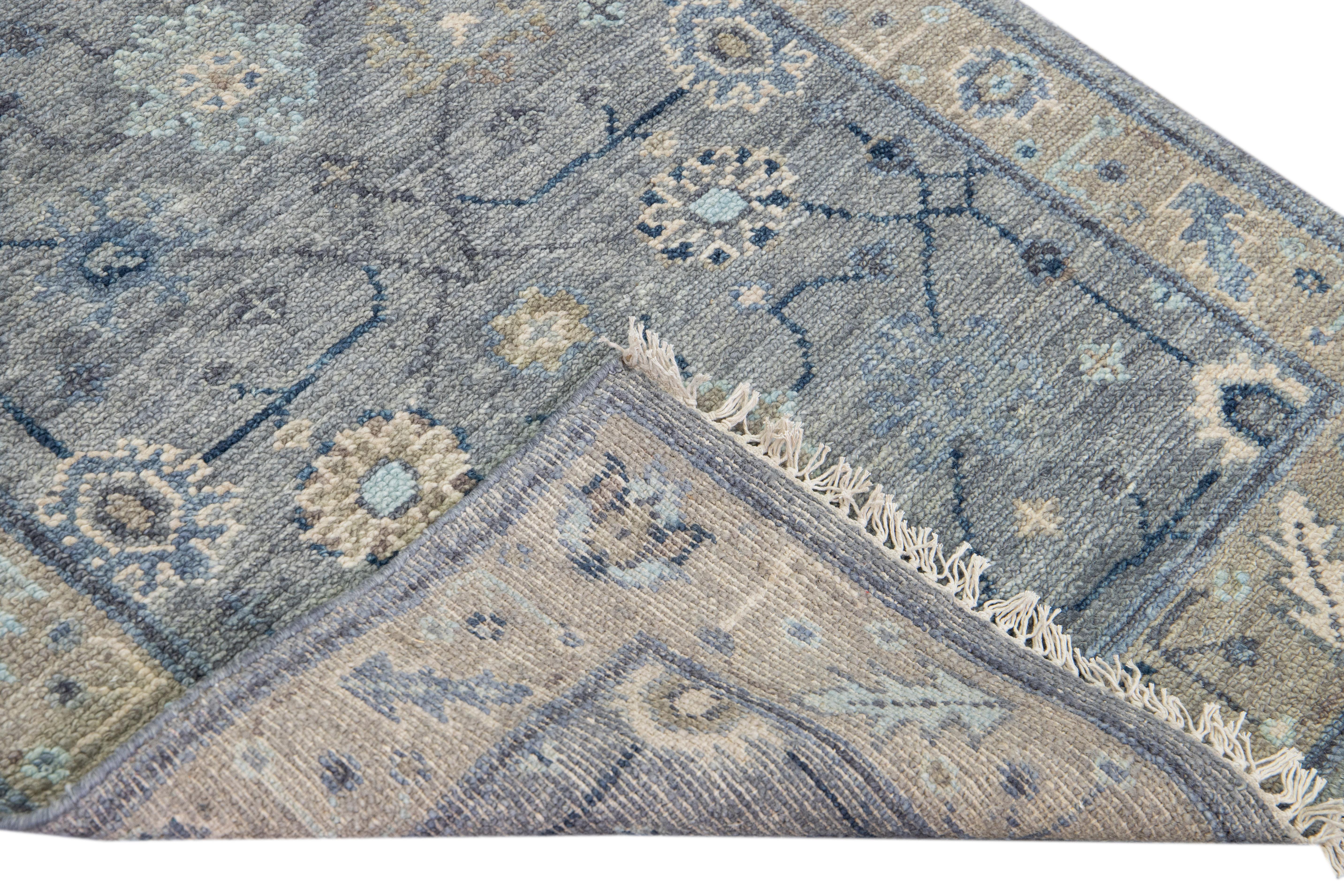 Beautiful modern Oushak hand-knotted wool runner with a gray field. This Oushak rug has a beige designed frame and blue accents all over a gorgeous floral design.

This rug measures 3' x 16'.

Our rugs are professional cleaning before shipping.