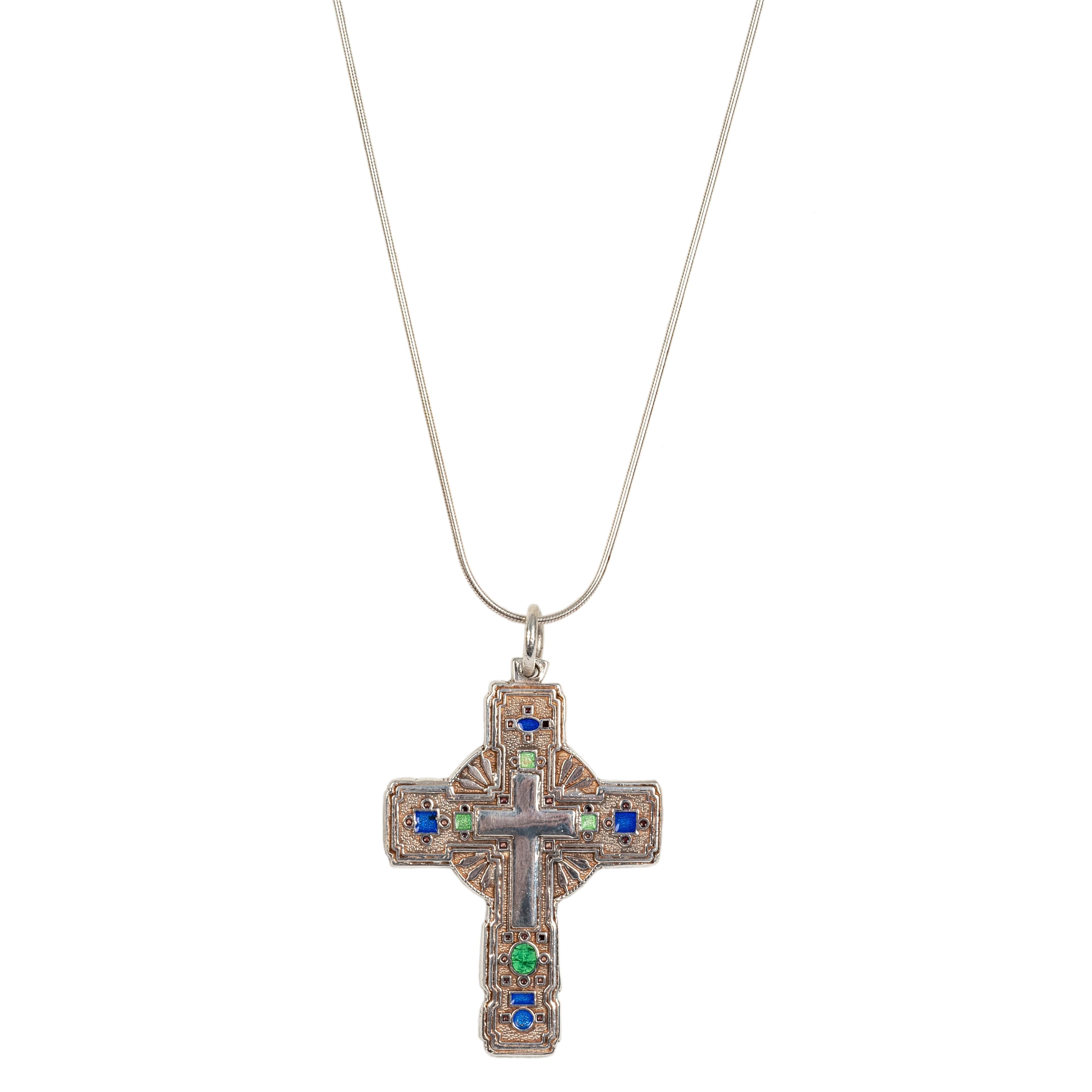 Of contemporary design in polished and matte silver, the front enameled with translucent green and blue enamel reserves enclosing a polished silver cross, attached to contemporary chain.

2 in. (5.1 cm) long including suspension ring; the chain 18