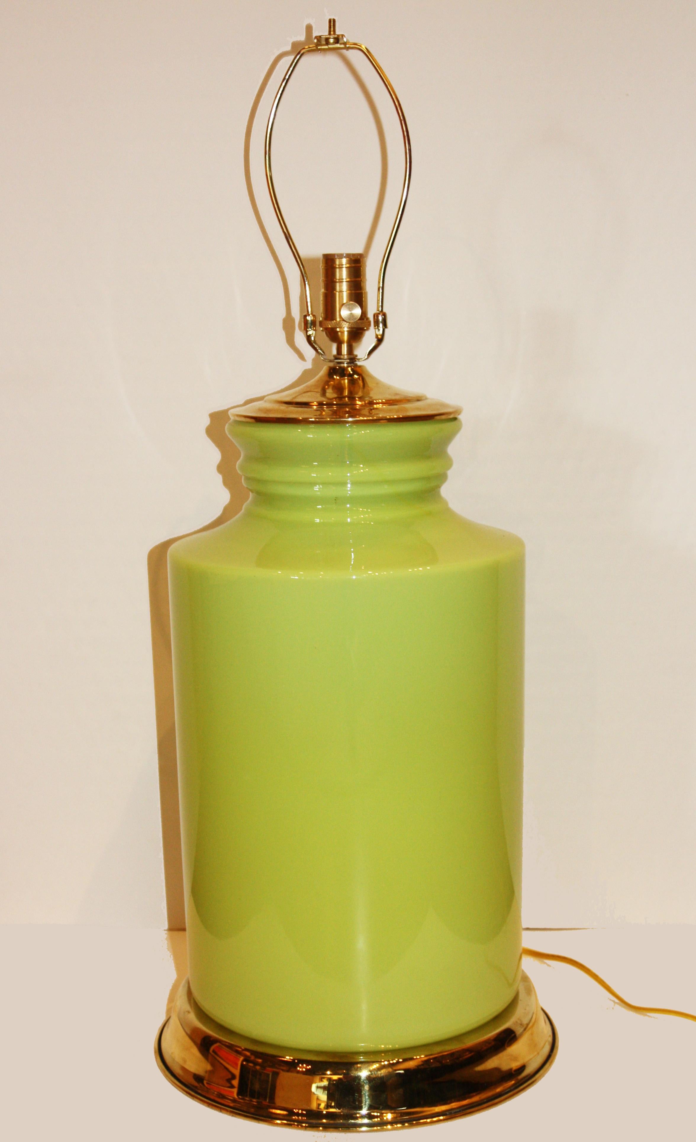 This is a green, porcelain lamp with a modern shape and brass accents. Fully functional, shade not included.