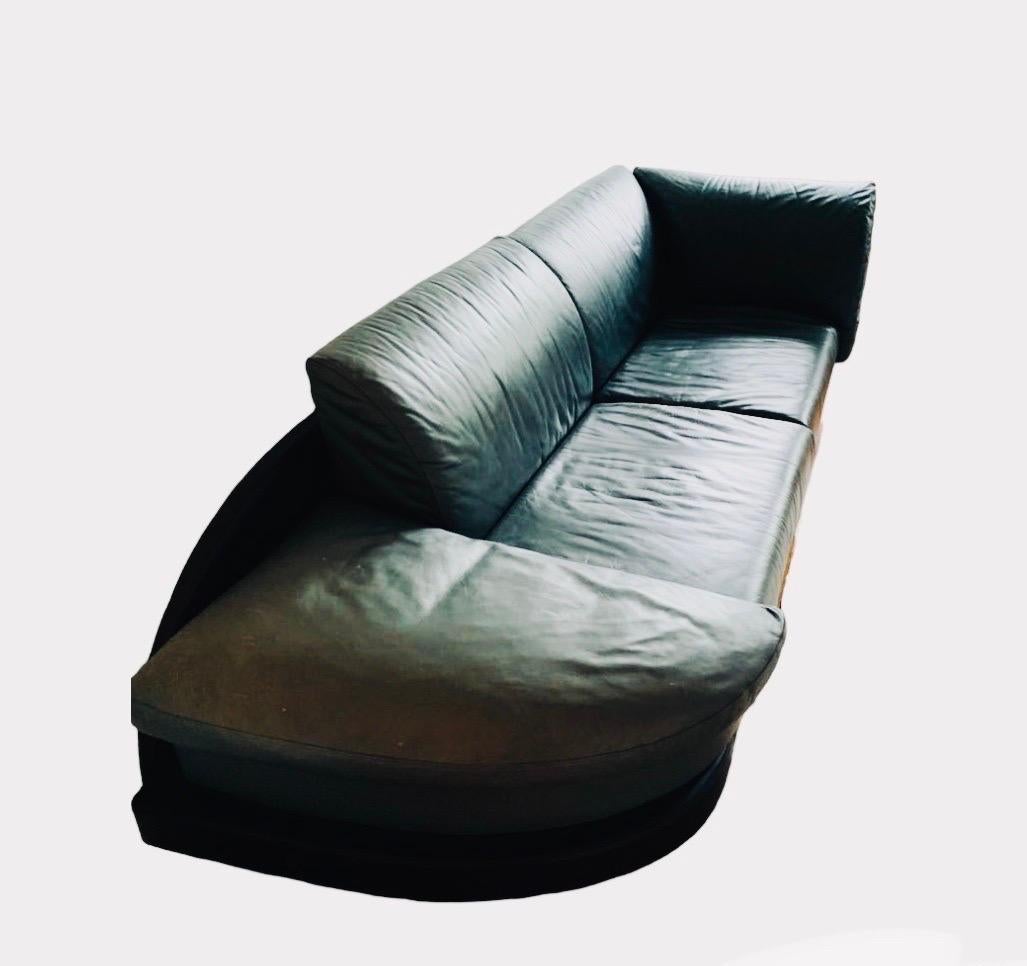 This is a green calf leather sofa by i4 Mariani for The Pace Collection. It is part of the  MD3 Molto + Di Seating Series, which made its debut in 1995. . 

It features a rounded back in contrasting black leather, and has geometrically shaped