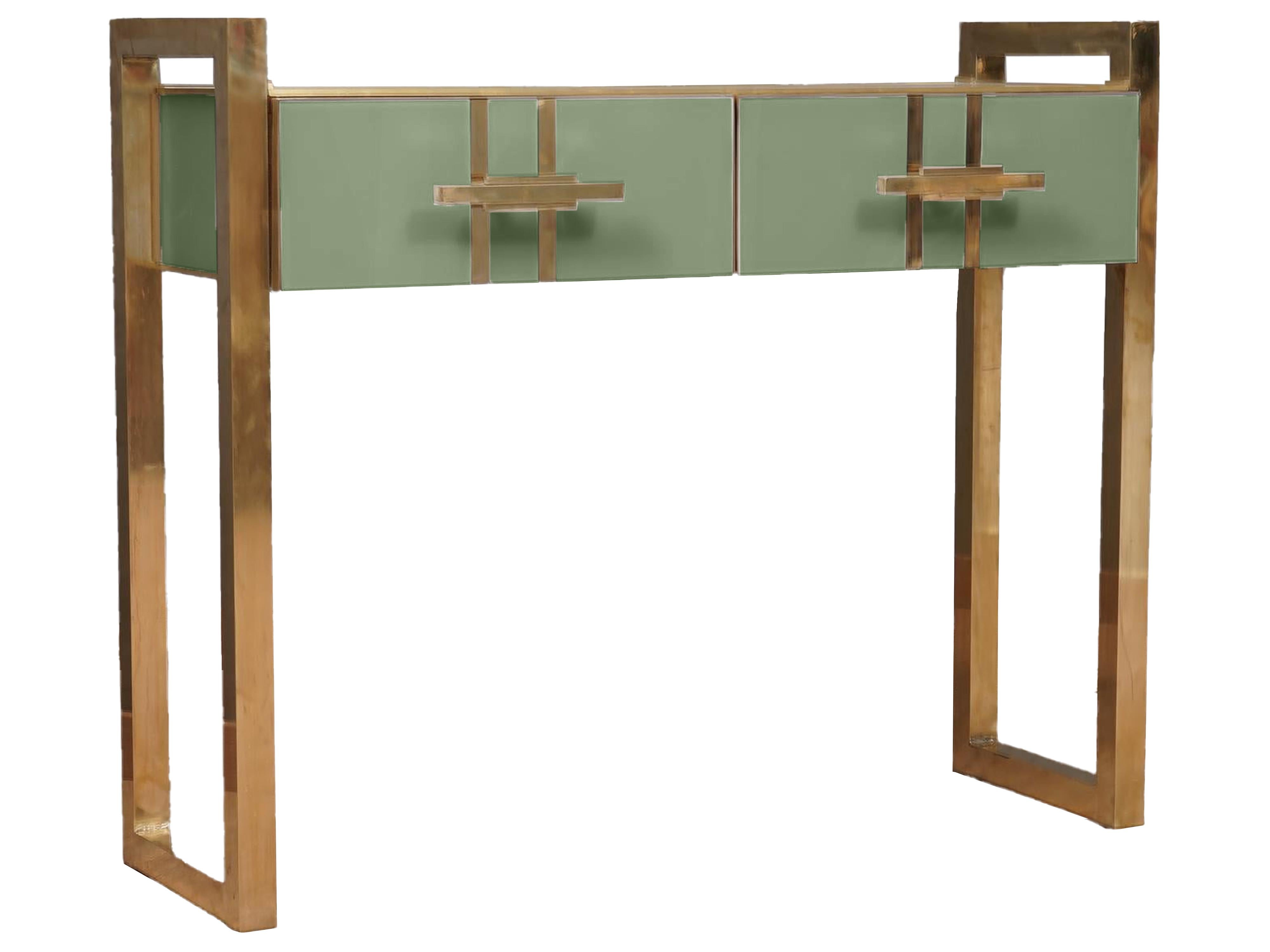 Introducing the Green Murano Glass Modern Console, a masterpiece of contemporary design that combines the timeless elegance of Murano glass with the sophistication of brass. 

This unique console features a solid wood frame, which ensures its