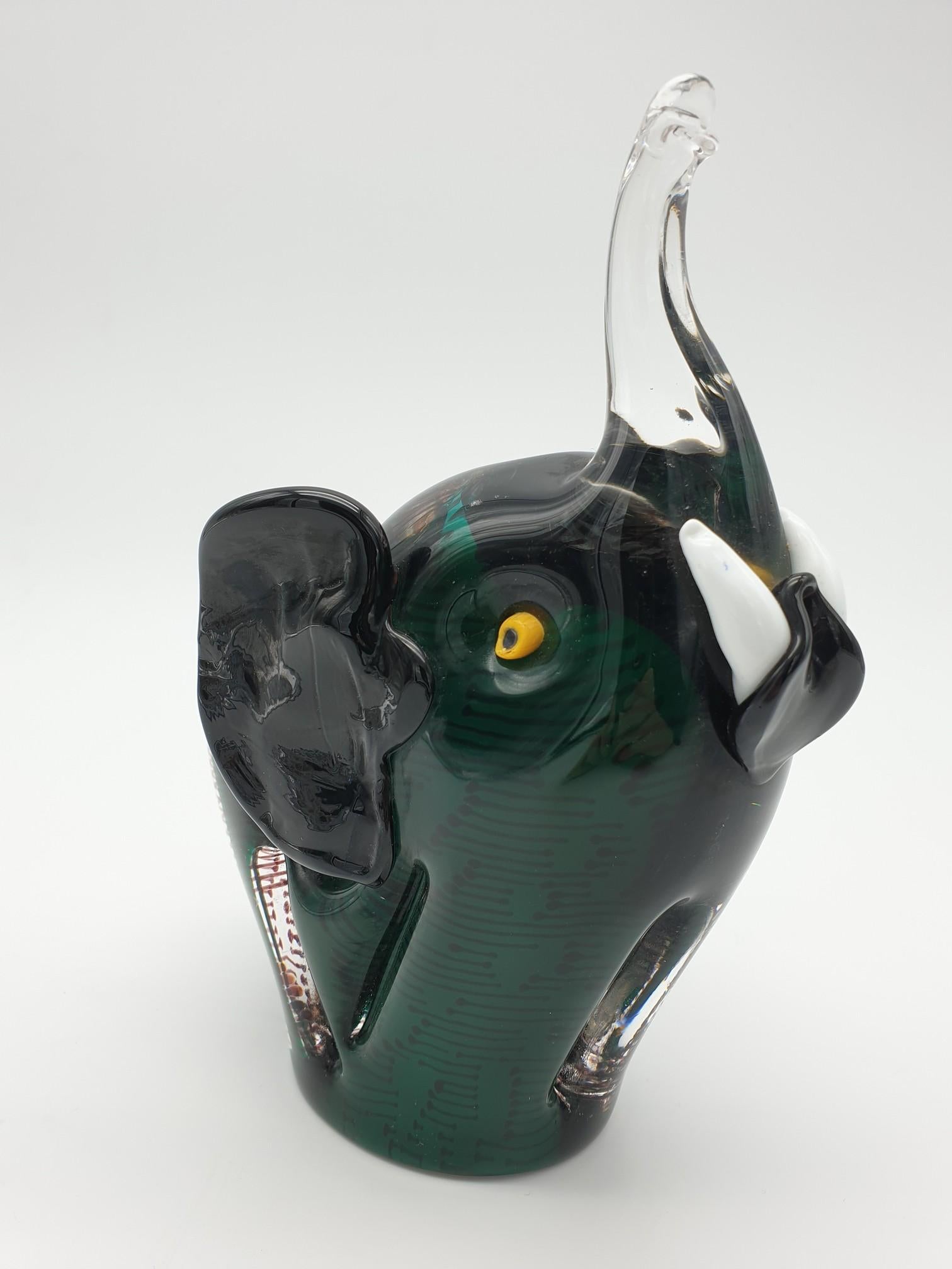 Cute glass elephant handmade by Gino Cenedese e Figlio in Murano. The stunning deep green color of this elephant is obtained by casing the substratal white glass layer with transparent pine green glass. As with every item manufactured at Cenedese,