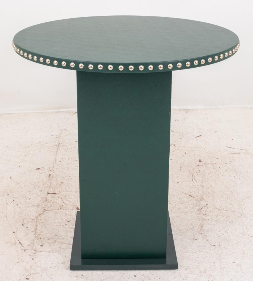 Modern high top table. Upholstered in textured green vegan leather with a studded edge, unmarked. In good condition. Wear consistent with age and use.

Dimensions: 42.25