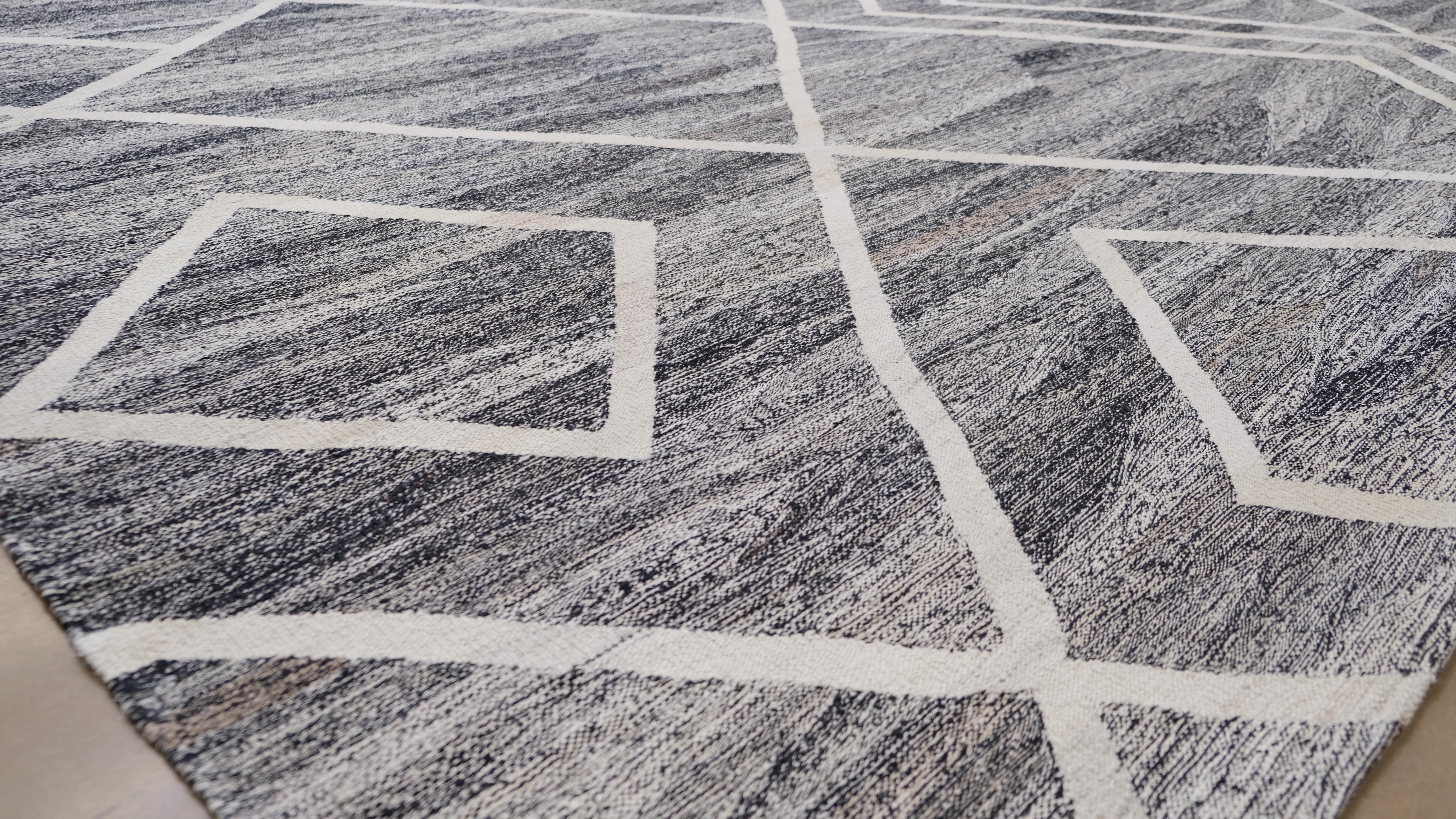 Add a modern yet timeless touch to your interior with this hand-woven wool kilim rug, featuring a bold geometric diamond pattern in sophisticated grey and white tones. Measuring an impressive 13' x 16'3