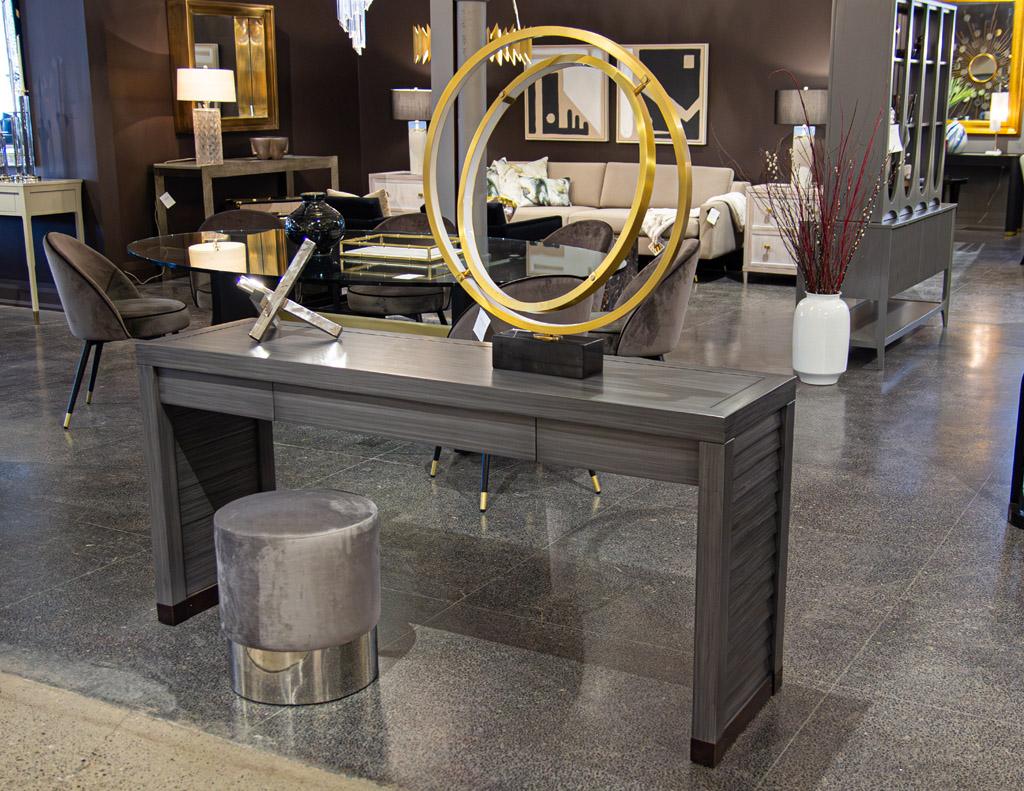 Newly made Modern grey console table is proudly crafted in the USA using high-quality walnut woods. This stunning piece boasts a beautiful textured grey lacquered finish, adding a touch of sophistication to any room. The attention to detail is
