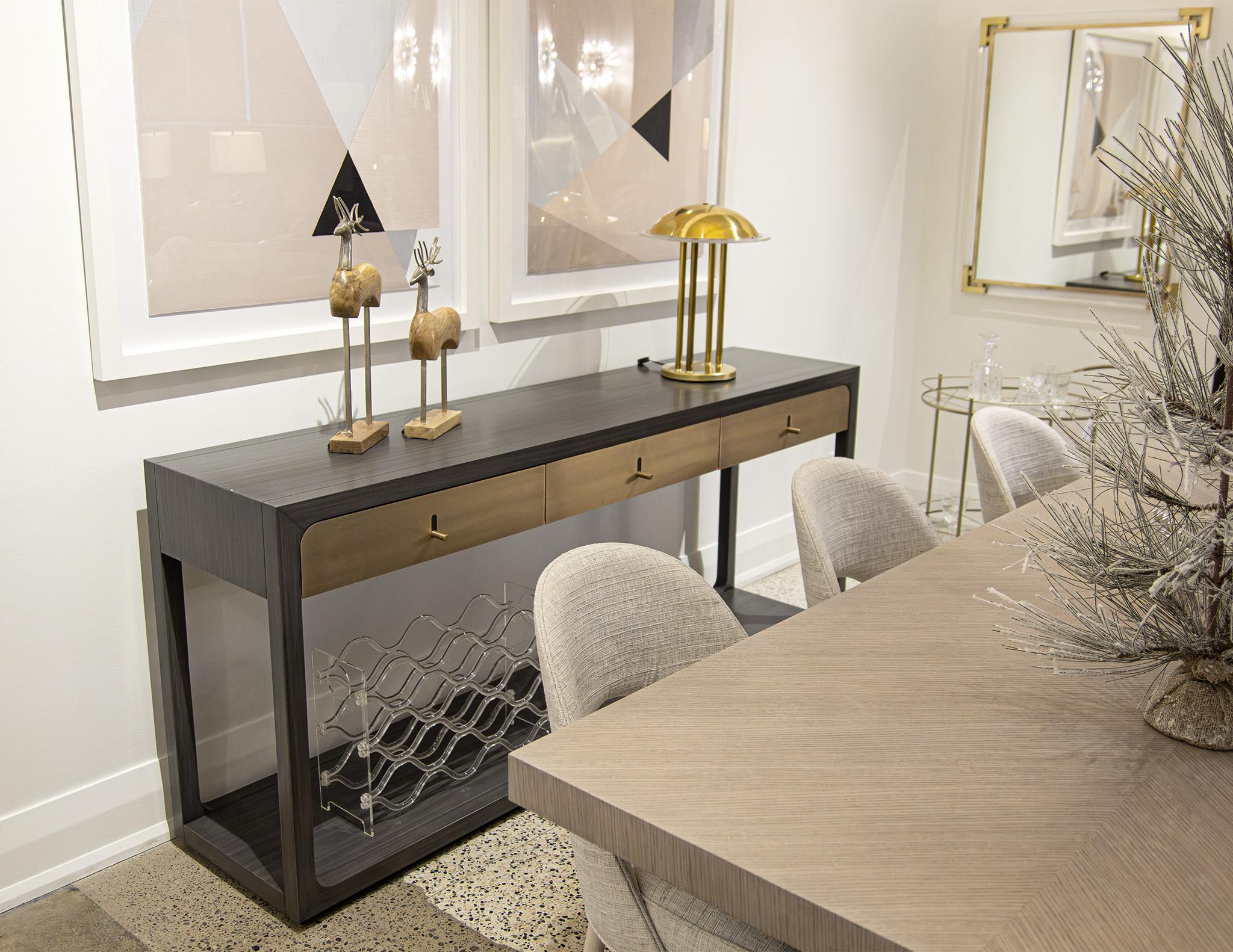 The Fulton Console by Joseph Jeup is the perfect addition to any modern space. This sleek and stylish console table features brass drawer fronts and hardware, walnut woods, and a striking grey satin lacquer finish. Its design is both modern and
