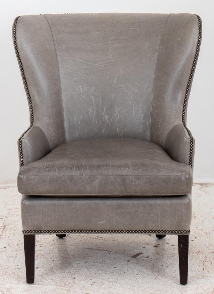 Crate & Barrel grey leather upholstered lounge arm chair, raised on square tapered wood feet, with 