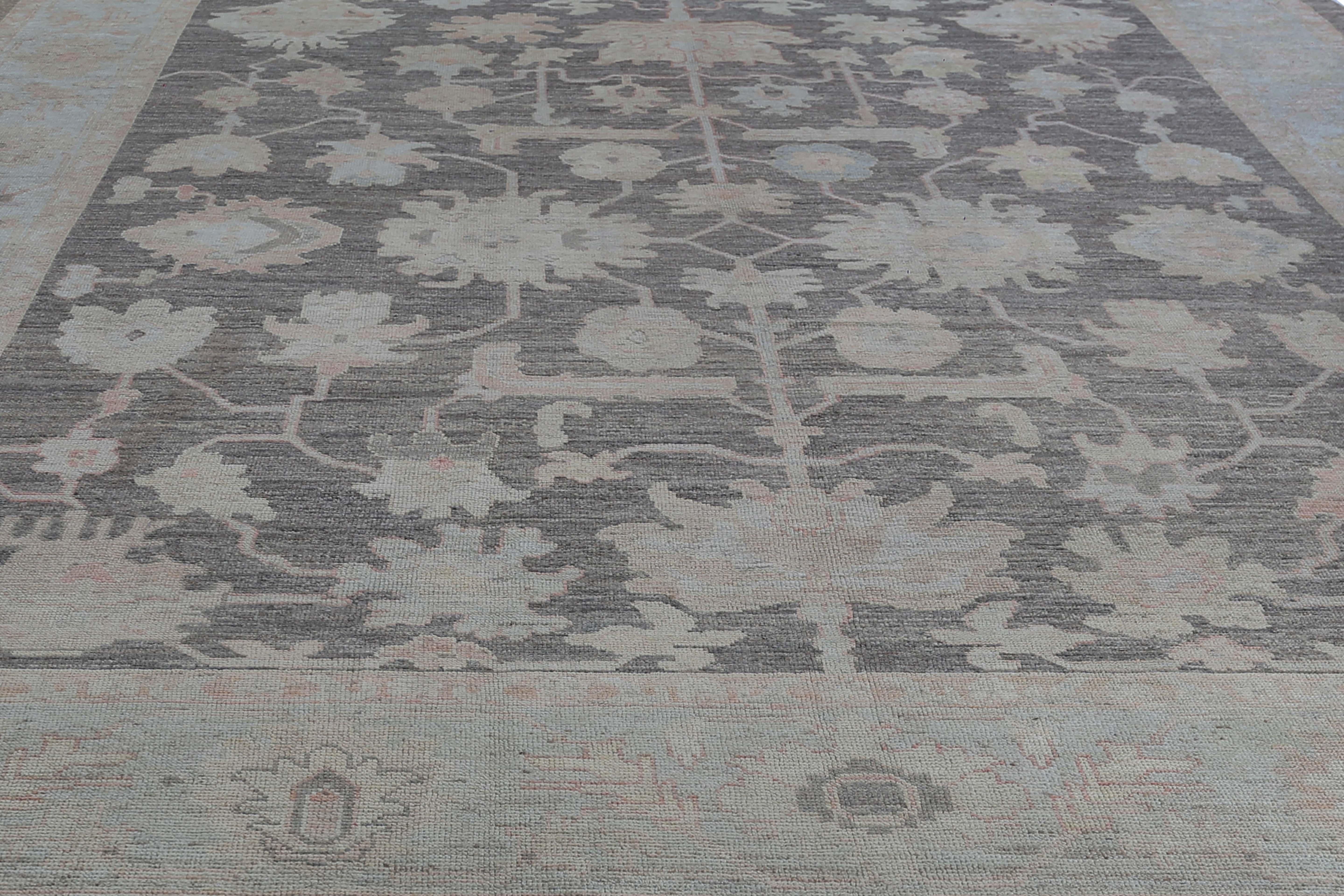 Add a touch of elegance and sophistication to your home with this stunning Turkish Oushak rug. Measuring 12'10
