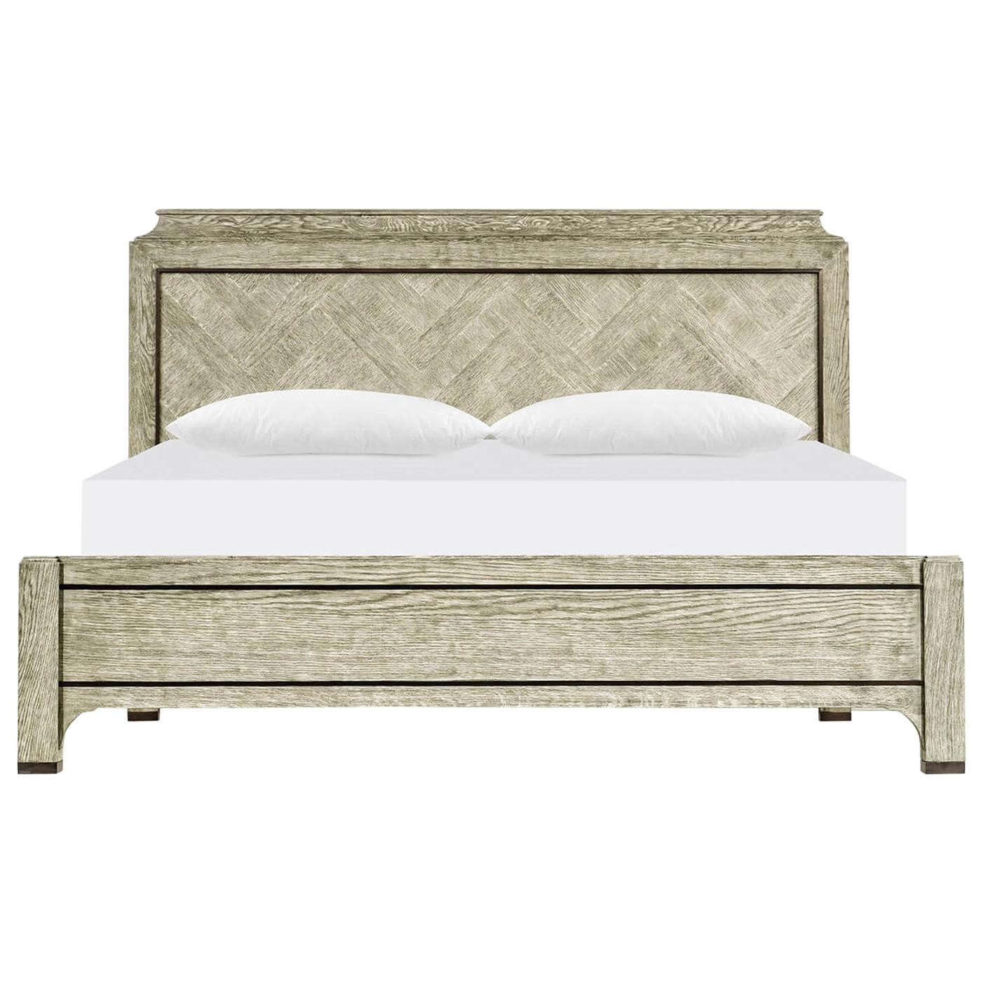 A modern greyed oak king size bed with herringbone parquetry headboard, with brass trim and square post legs.

Dimensions: 83 3/8