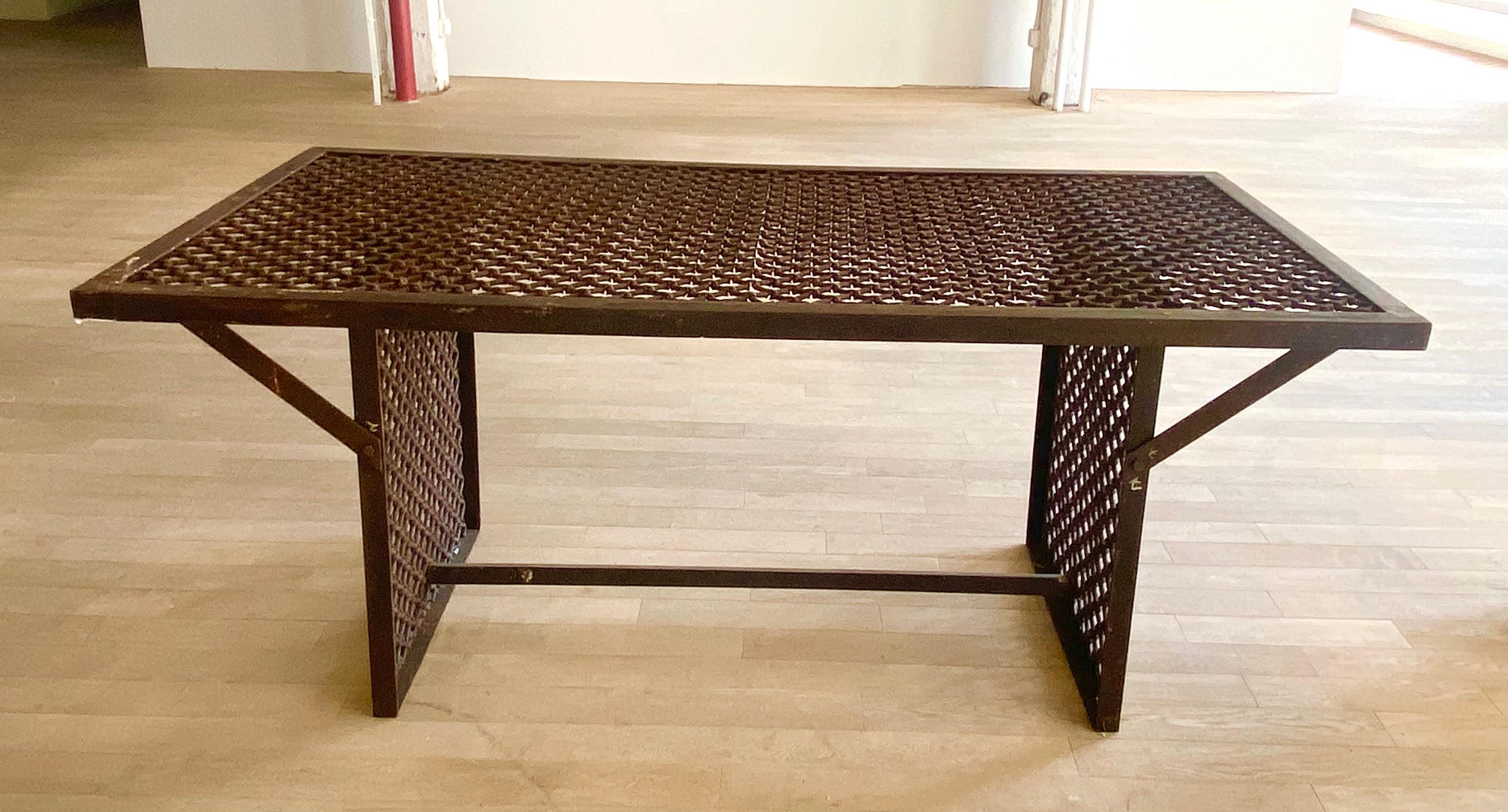 A unique and unusual iron table with a grill work top, with a central iron support connecting two grill work sides, modern, as is
Can be used as a large sofa table, dining table, desk, center table, or library table.  This table is extremely stable