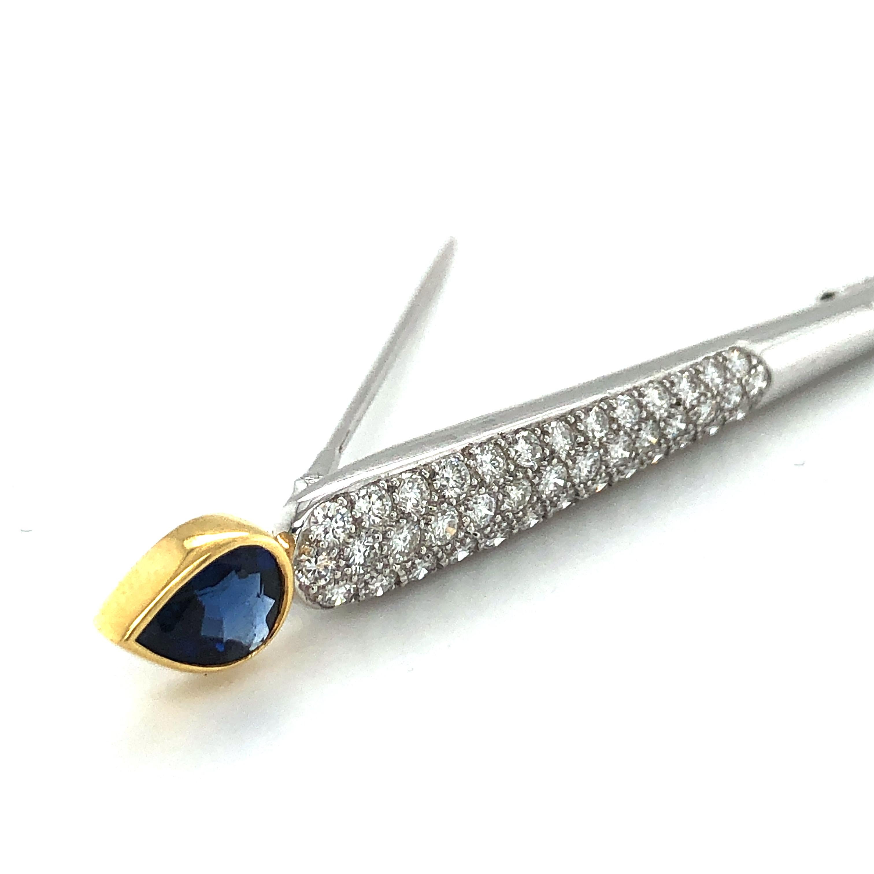 Modern bar pin from the early 2000 from Swiss Jeweler Gübelin. Longish brooch designed as an arrow, pavé set with 40 brilliant-cut diamonds totaling 1.04 ct. Ending in a yellow gold bezel set, richly saturated pear-shape sapphire of 1.74. ct.

This