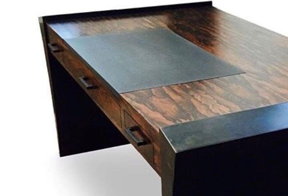 Modern gull wing desk in steel, stone and exotic ebony wood

A stunning mixed-media designed desk meticulously crafted in three different materials. Base is Blackened Steel and top is artisan crafted in Macassar ebony. Blotter is featured in