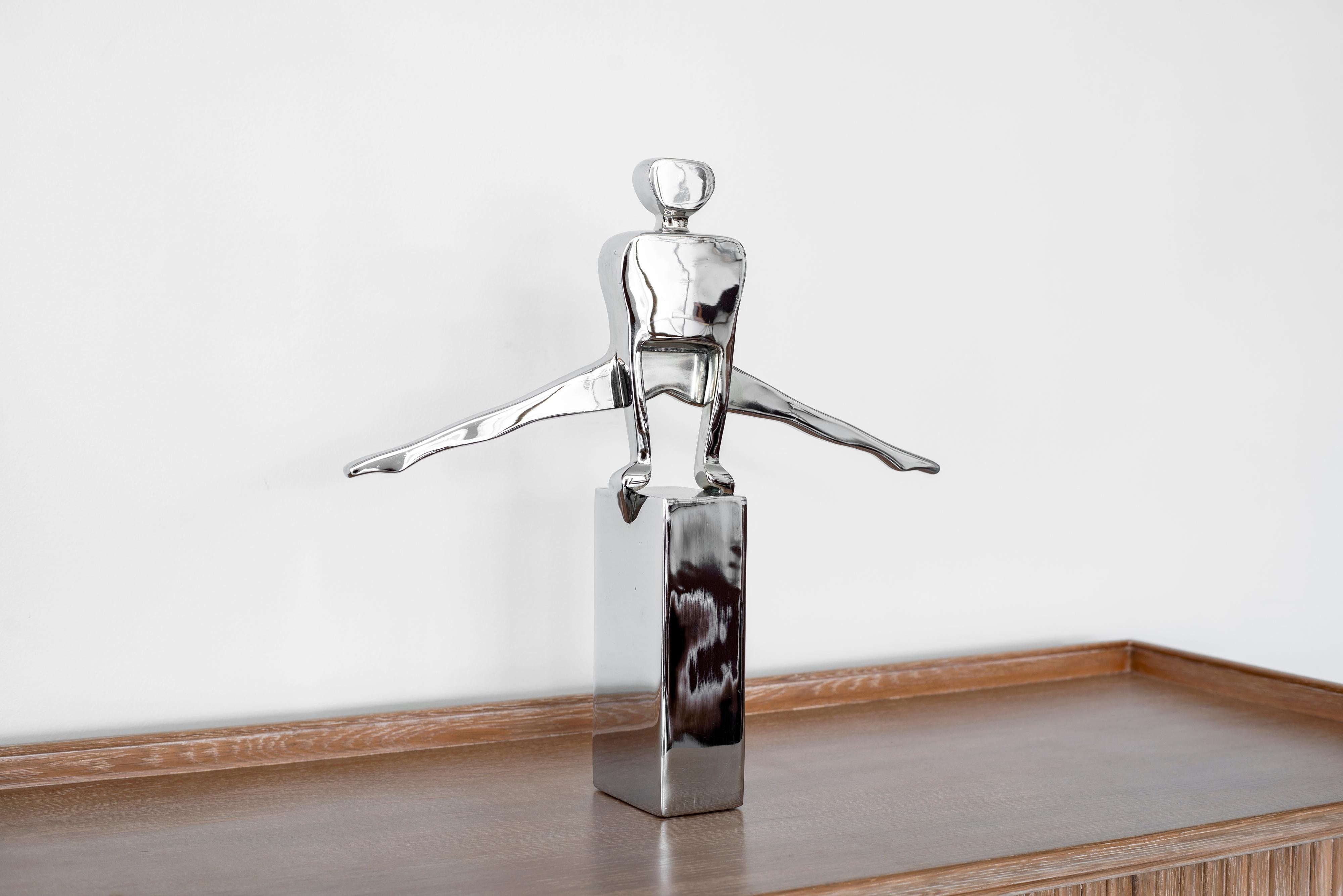 Heavy chrome sculpture of gymnast by Dolbi Cashier with original foil label dated 1987.
