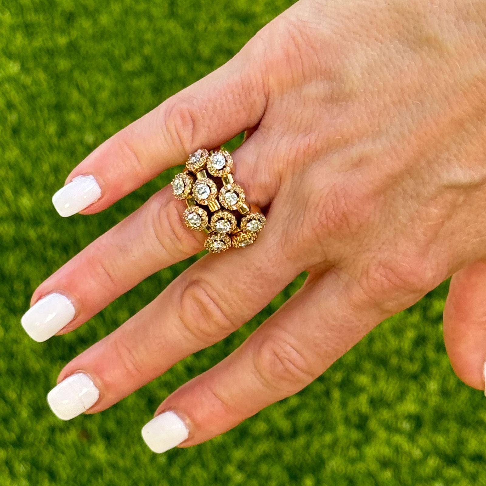 This 14 karat yellow gold diamond halo ring is a dazzling statement piece, featuring three rows of sparkling diamonds that come together elegantly in the back for a seamless look. With a total of 90 round brilliant cut diamonds, this ring boasts a