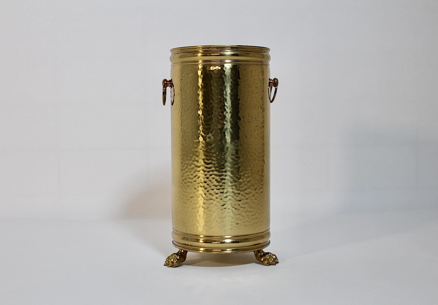 Modern vintage umbrella stand or cane holder from hammered brass sheet 1980s Italy.
A stunning vintage umbrella stand or cane holder from golden hammered brass sheet with 3 feet lions like. 3 feet make you sure, that this umbrella stand will stand