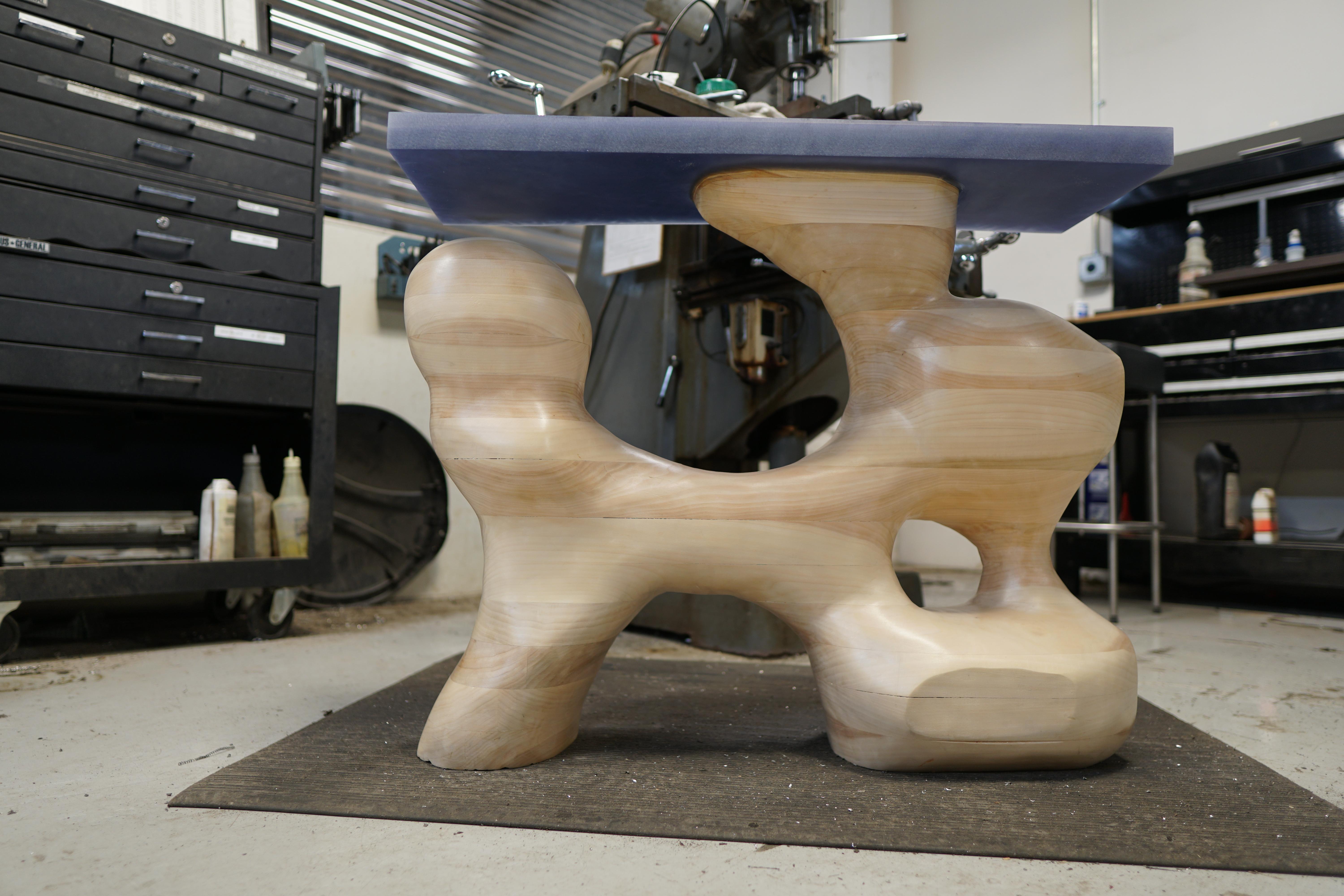 This one-of-a-kind modern organic piece can be used as an end or side table. Made of local poplar and carved with chainsaw, angle grinder and sanded, approximately 50 hours of expert craftmanship went into the creation of this piece. Inspired by the