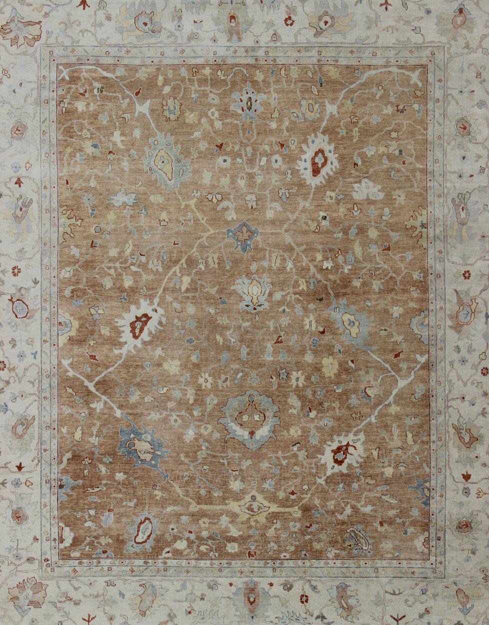 Oushak rug with blue, cream, and coral, neutral color palette and all-over flower design, Keivan Woven Arts / rug/BDH-743526, country of origin / type: India/ Oushak

This hand knotted Oushak rug features a beautiful design rendered in light blue,