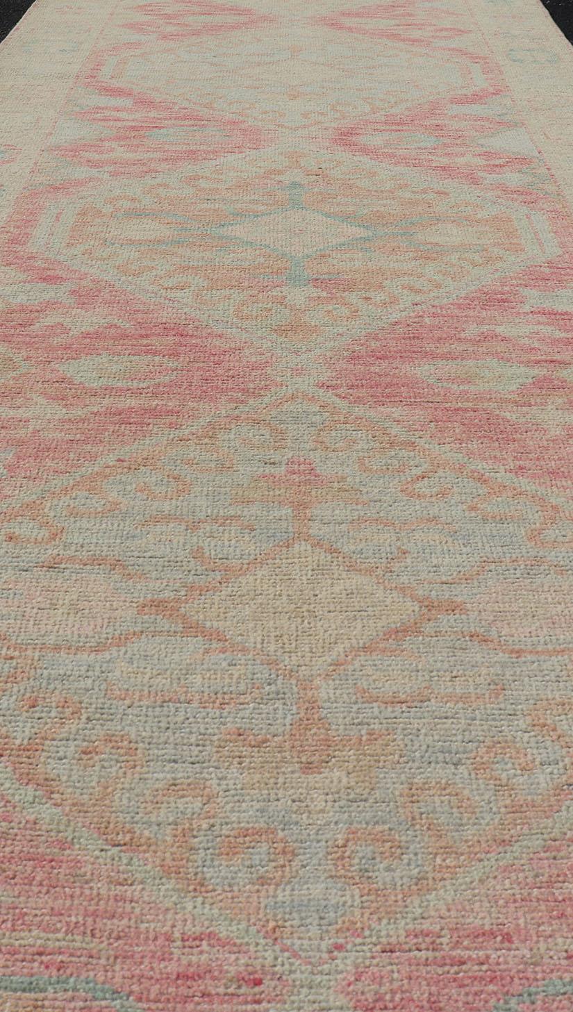 Modern Hand Knotted Oushak Runner With Medallions in Pink's and Creams. Keivan Woven Arts; AWR-4982 Country of Origin: Afghanistan Type: Oushak Design: Tribal,

Measures: 3'0 x 12'9

This long Oushak runner has a light pink background with a cream