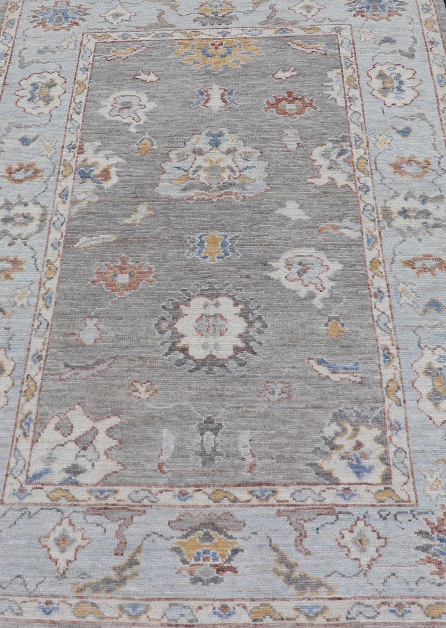 This beautiful rug starts in a light gray background, paired with a steel blue in the border. The design is an all-over Oushak floral design, highlighting unique colors, such as gold, cream, rusty orange, and blues.


Keivan Woven Arts; rug