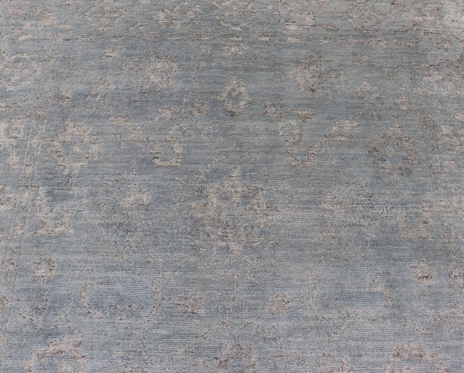 Alfombra moderna anudada a mano en lana con diseño floral en azul y gris 6' x 9' Indio en venta