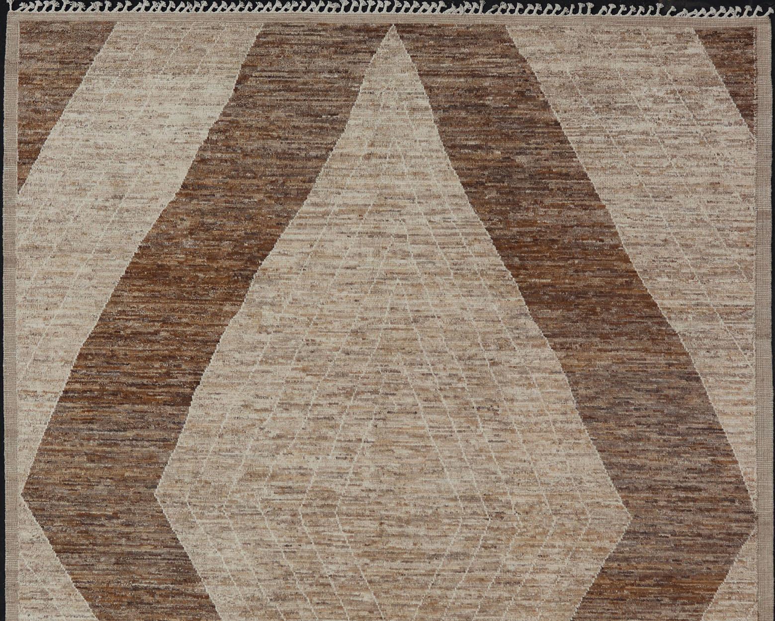 This modern casual tribal rug has been hand-knotted in wool. The rug features a large modern diamond design, rendered in brown, tan, and cream; making this rug a superb fit for a variety of interiors.

Modern hand-knotted rug in wool With Modern