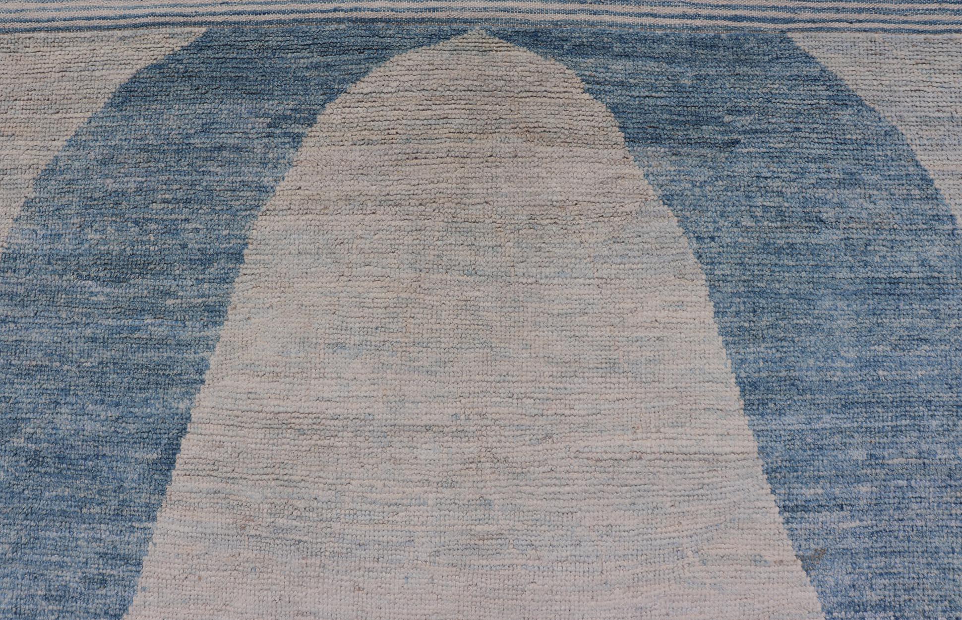 This modern casual tribal rug has been hand-knotted in wool. The rug features a modern sub-geometric design, rendered in blue and cream; making this rug a superb fit for a variety of interiors.

Modern casual tribal rug, Keivan Woven Arts; rug
