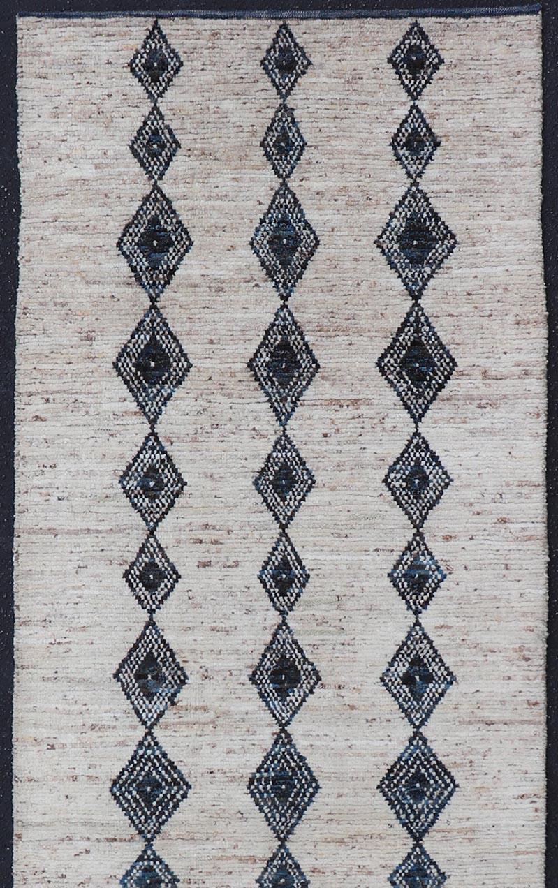 Modern Hand-Knotted Runner in Wool with Diamond Design in Blue and Ivory. Keivan Woven Arts; rug SNK-2270, country of origin / type: Afghanistan / Modern Casual, circa Early-21th Century.
Measures: 3'1 x 10'1 
This modern casual tribal runner has