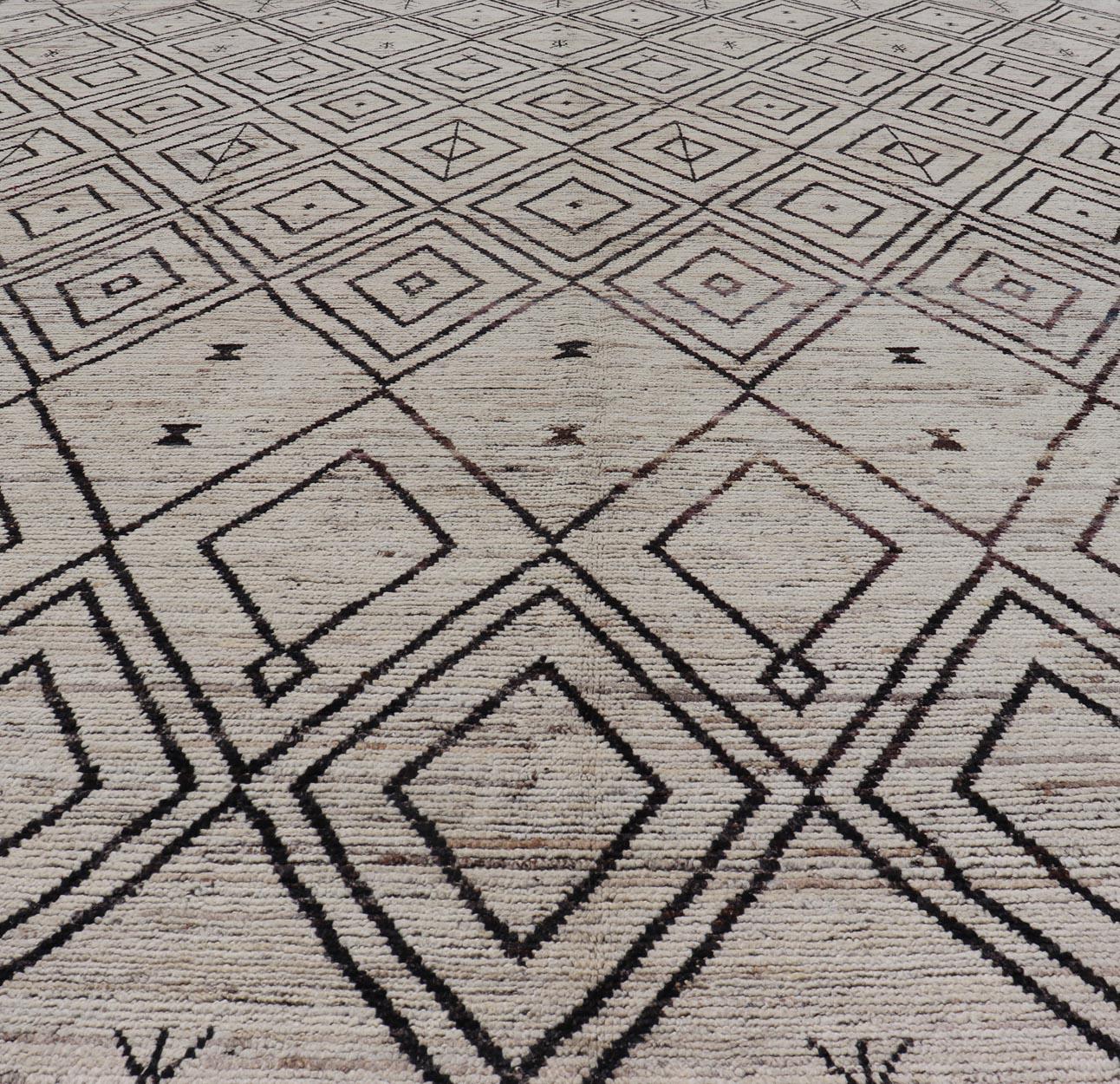 This modern casual tribal Moroccan rug has been hand-knotted. The rug features a modern all-over geometric diamond design, replete with various motifs in neutral and earthy tones; making this rug a superb fit for a variety of classic, modern, casual