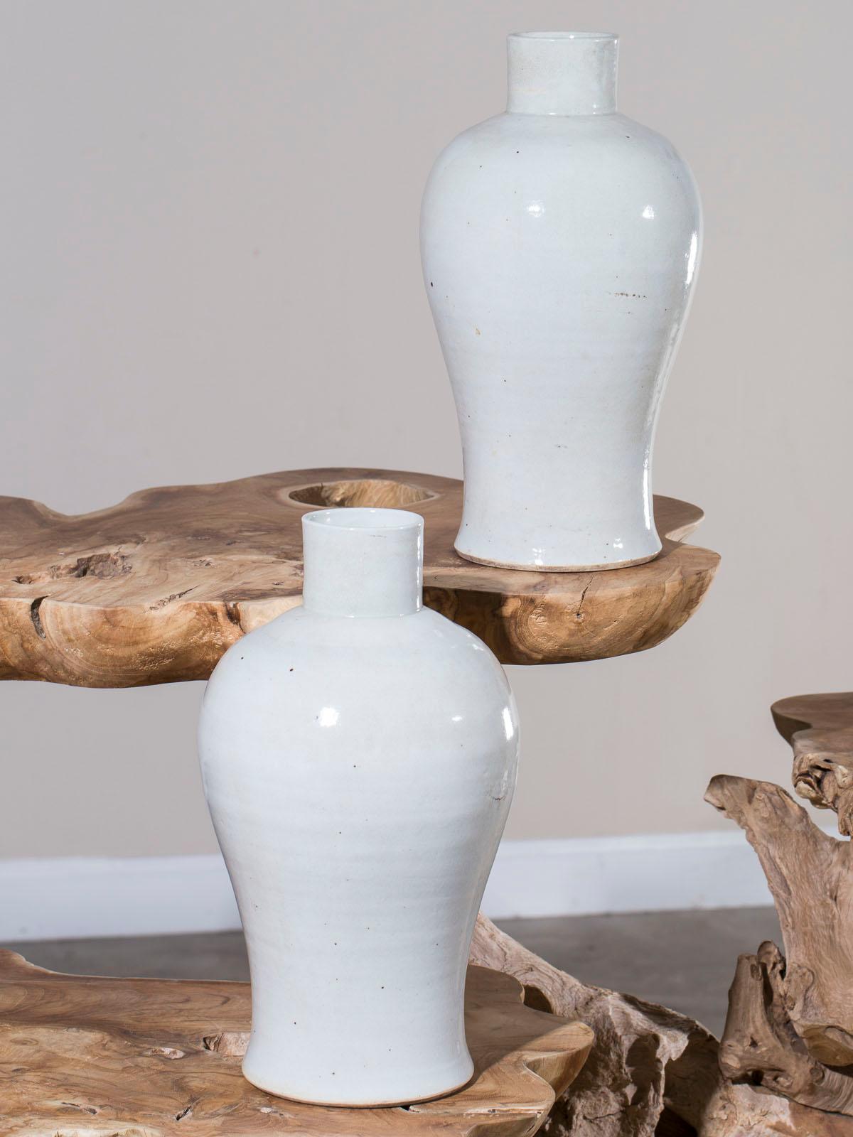 Two modern hand made Chinese Mei Ping glazed ceramic vases with a monochromatic color. This type of vase with a narrow neck atop a larger body became known as 