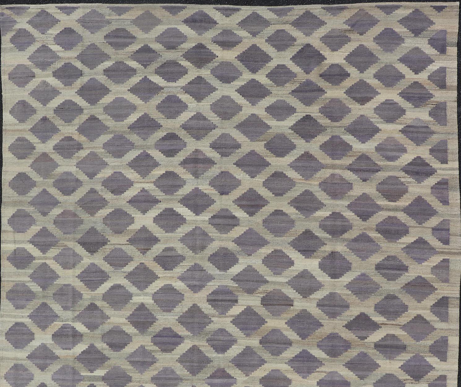 This flat-weave kilim has been hand-woven. The rug features a modern all-over geometric diamond design, rendered in shades of gray, cream and brown; making this rug a superb fit for a variety of classic, modern, casual and minimalist